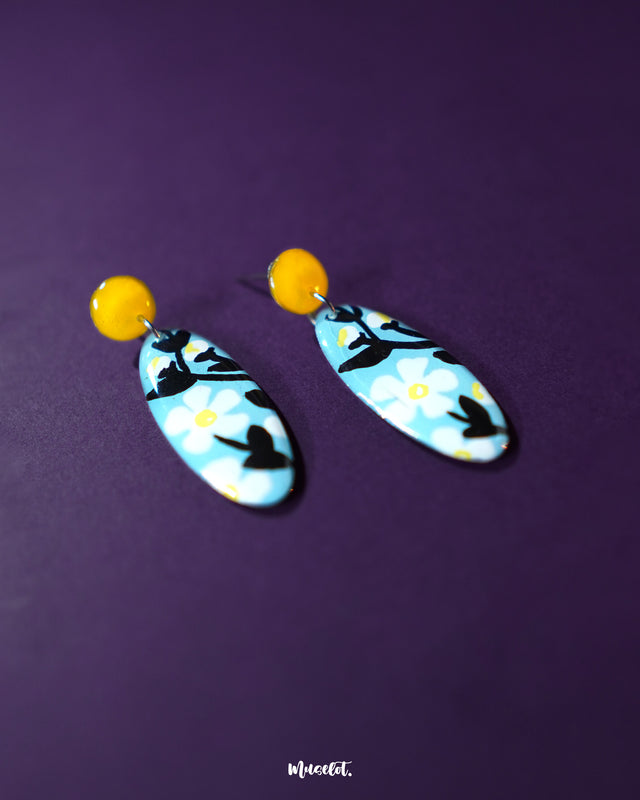 Shaamgul drop earrings captured from a side angle, highlighting their detailed petal structure and dangling beads that lend a graceful, bohemian appeal — Muselot.