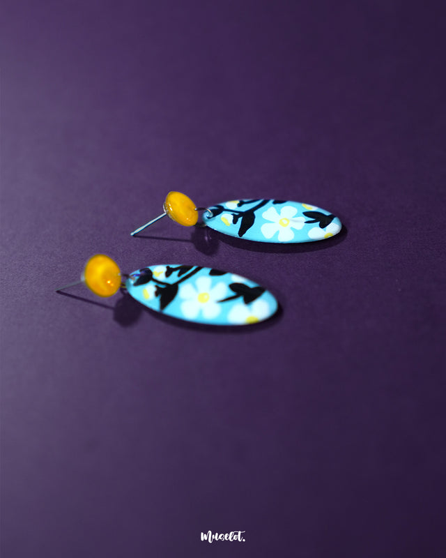 Close-up of the Shaamgul drop earrings showcasing the delicate design of the floral top and cascading metallic elements, emphasizing their handcrafted charm — Muselot.