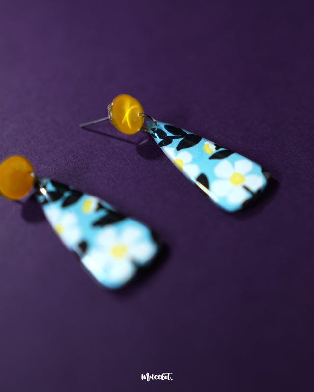 Shaamgul floral drop earrings displayed against a soft backdrop, showcasing the detailed floral design and dangling bead elements that add a graceful, handcrafted touch — Muselot.