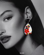A close-up shot of the model wearing the Shafaq drop earrings, highlighting the intricate craftsmanship and the way the delicate drops frame the face with subtle elegance — Muselot.