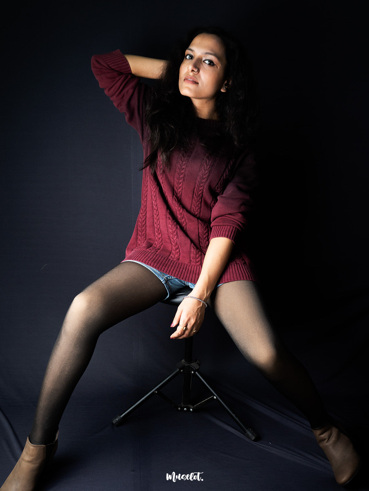 A model sitting on chair highlights the texture of the tights  making the overall look both stylish and comfortable - Muselot