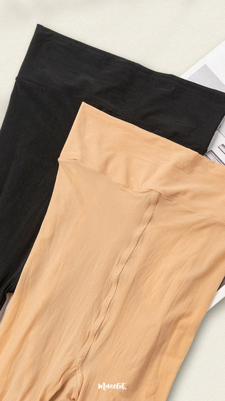 A pair of black and skin-colored stockings are placed on a plain white background, showcasing their sleek, smooth texture and versatile colors. The contrast between the two highlights their different tones, making them ideal choices for various outfits and occasions. -Muselot