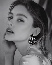  a model wearing Siyahgul black earrings, featuring a sleek silhouette and intricate design that exude bold sophistication and modern elegance — Muselot.