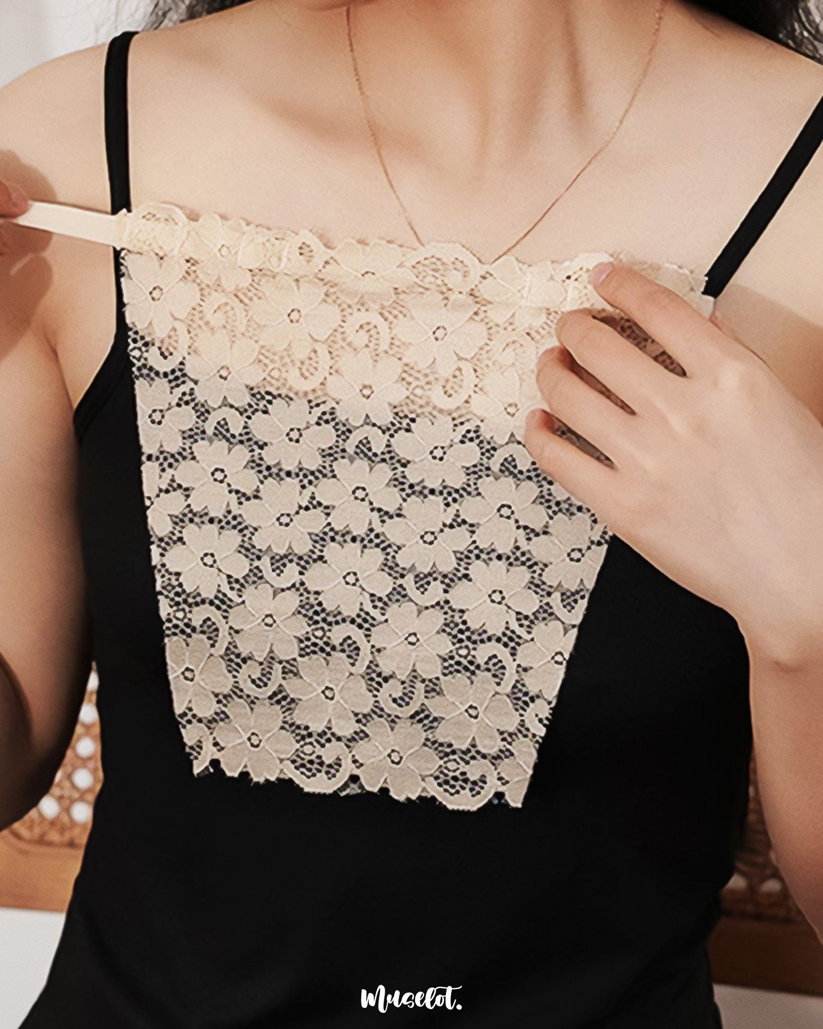 Close-up of a model wearing a skin-tone mocker underneath a black top, emphasizing the natural blend of the mocker with the skin and the sheer texture of the top, creating a seamless, elegant layering effect — Muselot.