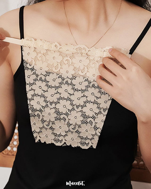 Close-up of a model wearing a skin-tone mocker underneath a black top, emphasizing the natural blend of the mocker with the skin and the sheer texture of the top, creating a seamless, elegant layering effect — Muselot.