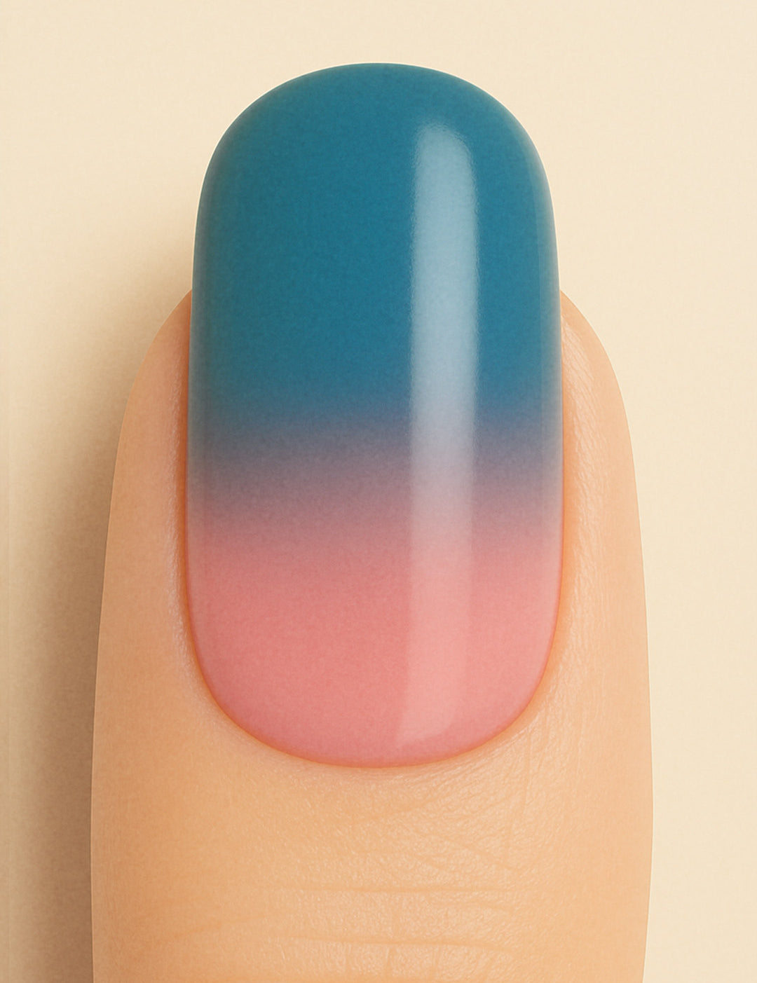 A close-up shot of a model’s finger wearing Twilight Rose Ombre nail stickies, showcasing the seamless transition from a muted rose pink at the base to a deep teal-blue at the tip, highlighting the modern elegance and smooth glossy finish of gradient nail art – Muselot.