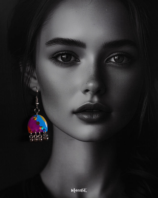 a model wearing Ufaq hook multicolor earrings, where bold hues and intricate patterns create a striking contrast, highlighting the earrings' playful yet elegant design — Muselot.