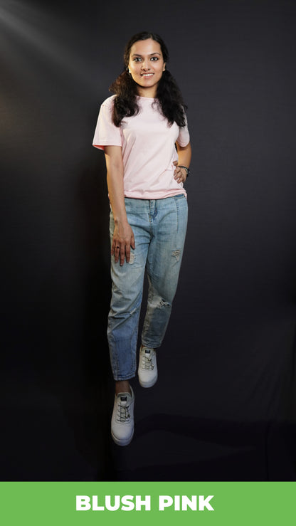 A beautiful model confidently poses against a dark background, wearing a casual, plain round-neck t-shirt with half sleeves,  highlighting a modern relaxed fit-muselot