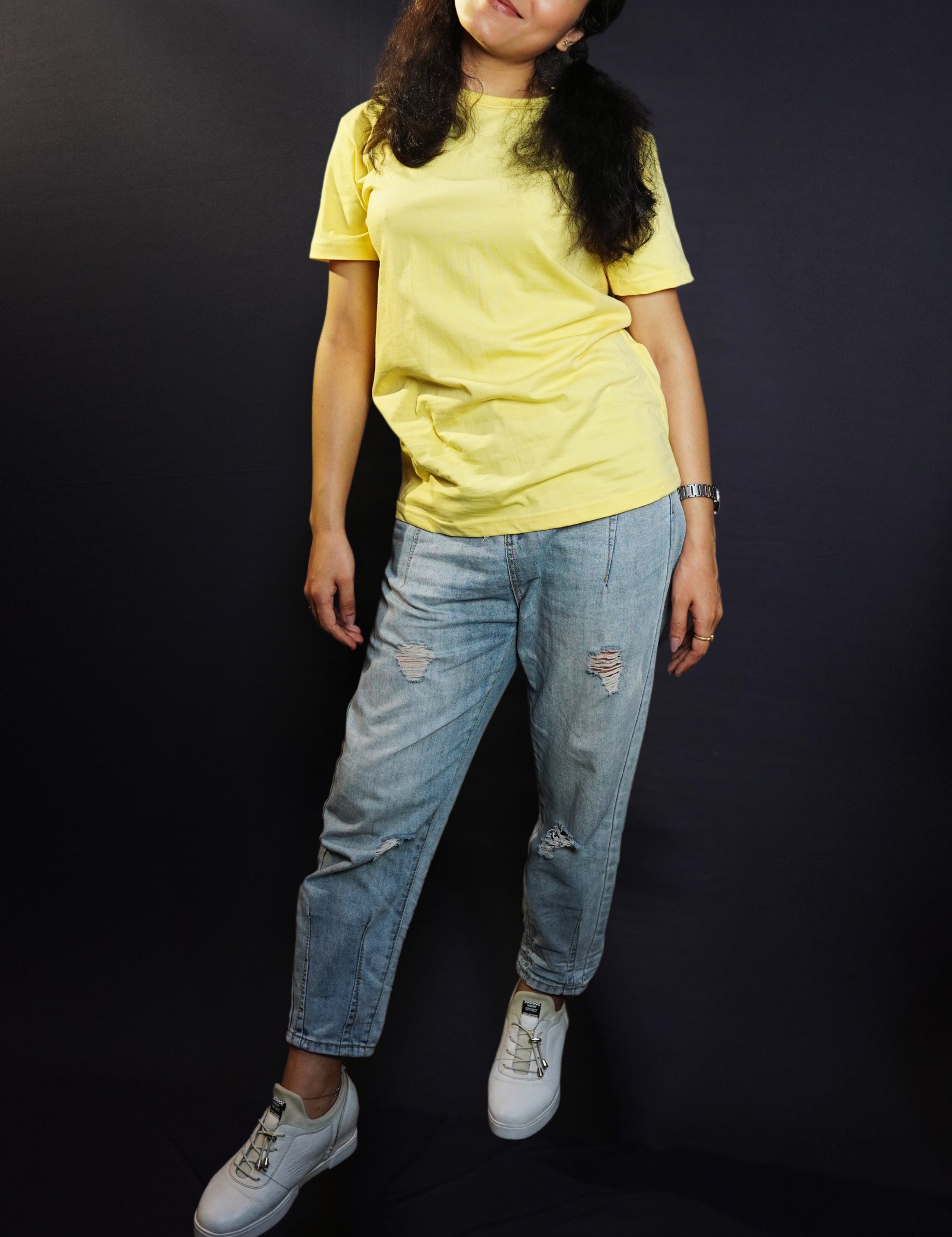 A woman posing as she slightly bend to her side, wearing butter yellow plain quick drying t-shirt, highlighting a cool breathable fit-Muselot