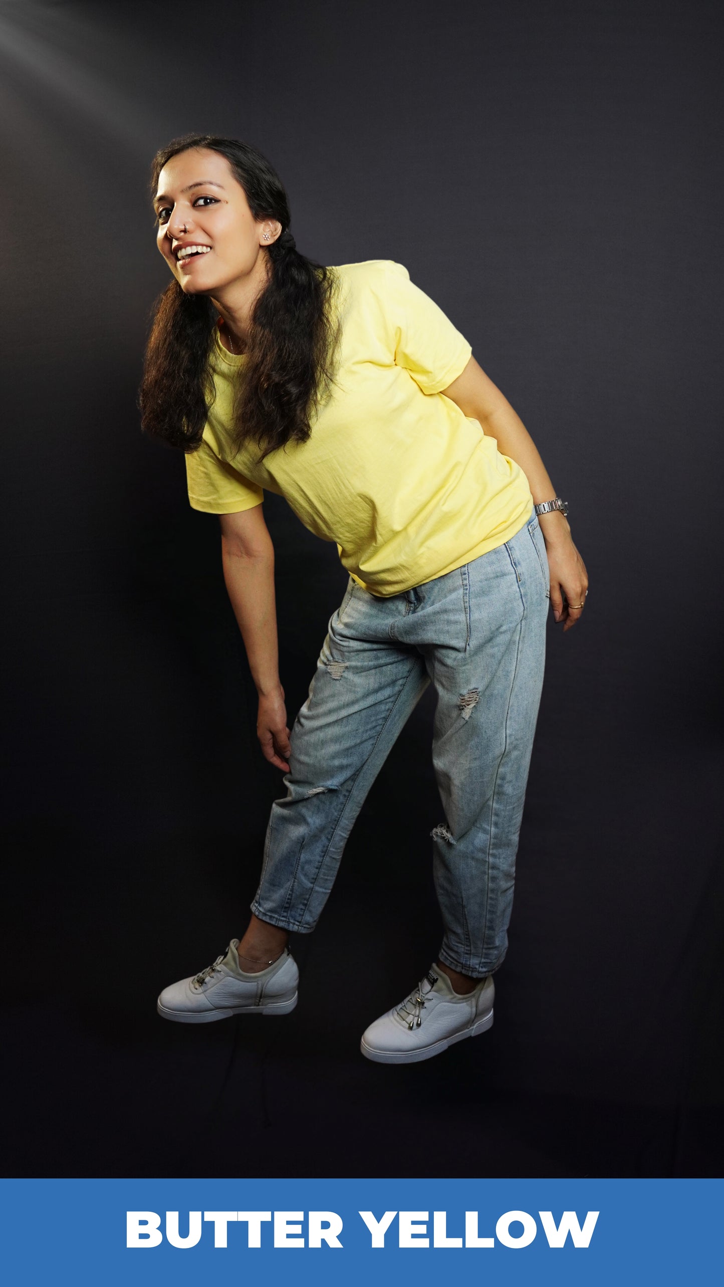 A woman posing happily as she stands sideways bending forward, wearing adult's quich drying round neck short sleeved t-shirt, highlighting a popular snug fit-Muselot