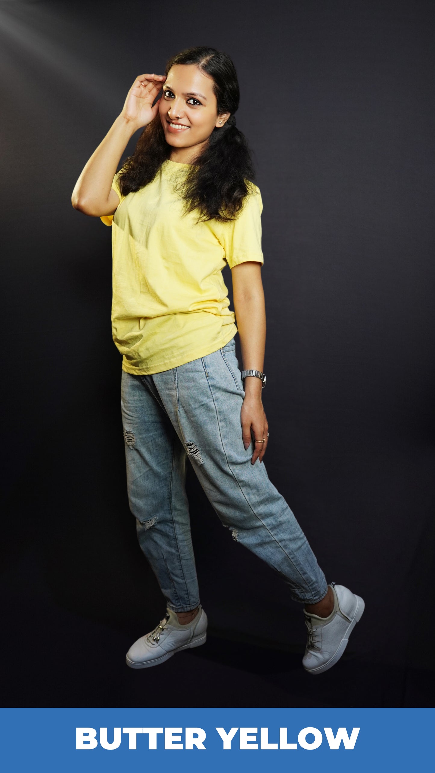 A stylish model posing with her hand on the side of her head as she sways slightly to her side, wearing a comfortable plain plus size unisex butter yellow t-shirt, highlighting a fashionable baggy fit-Muselot