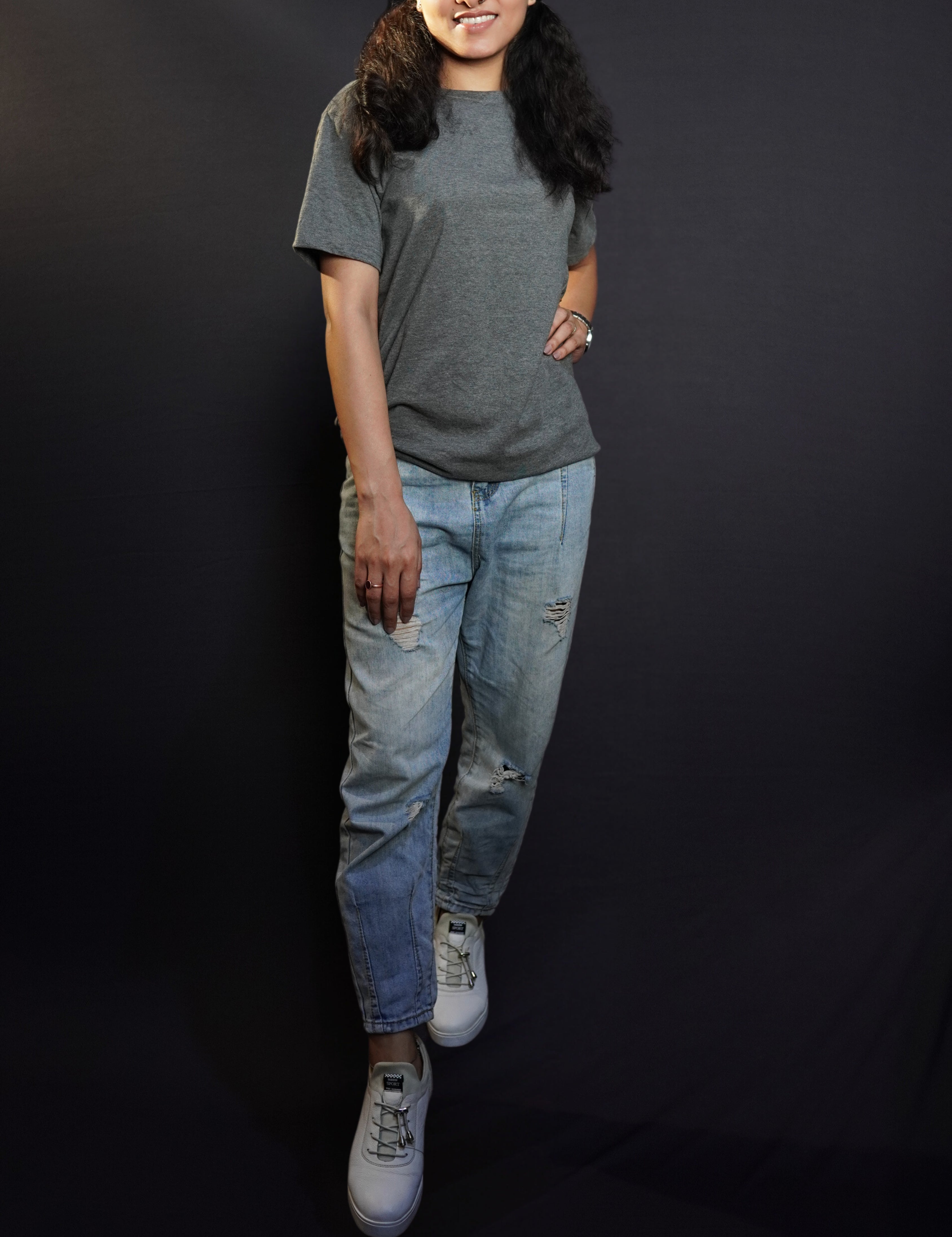 a stylish model posing confidently in round neck stretchable plain t shirt looking directly at the camera with a smile on her face-muselot