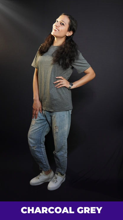 a stylish model in a trendy charcoal grey plain casual t shirt with ripped jeans laughing happily-muselot