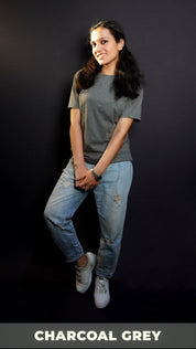 A stylish model with a smile on her face wearing long length t shirt pairing with ripped jeans and white shoes and a silver watch around her wrist, highlighting the comfy and casual outfit-Muselot