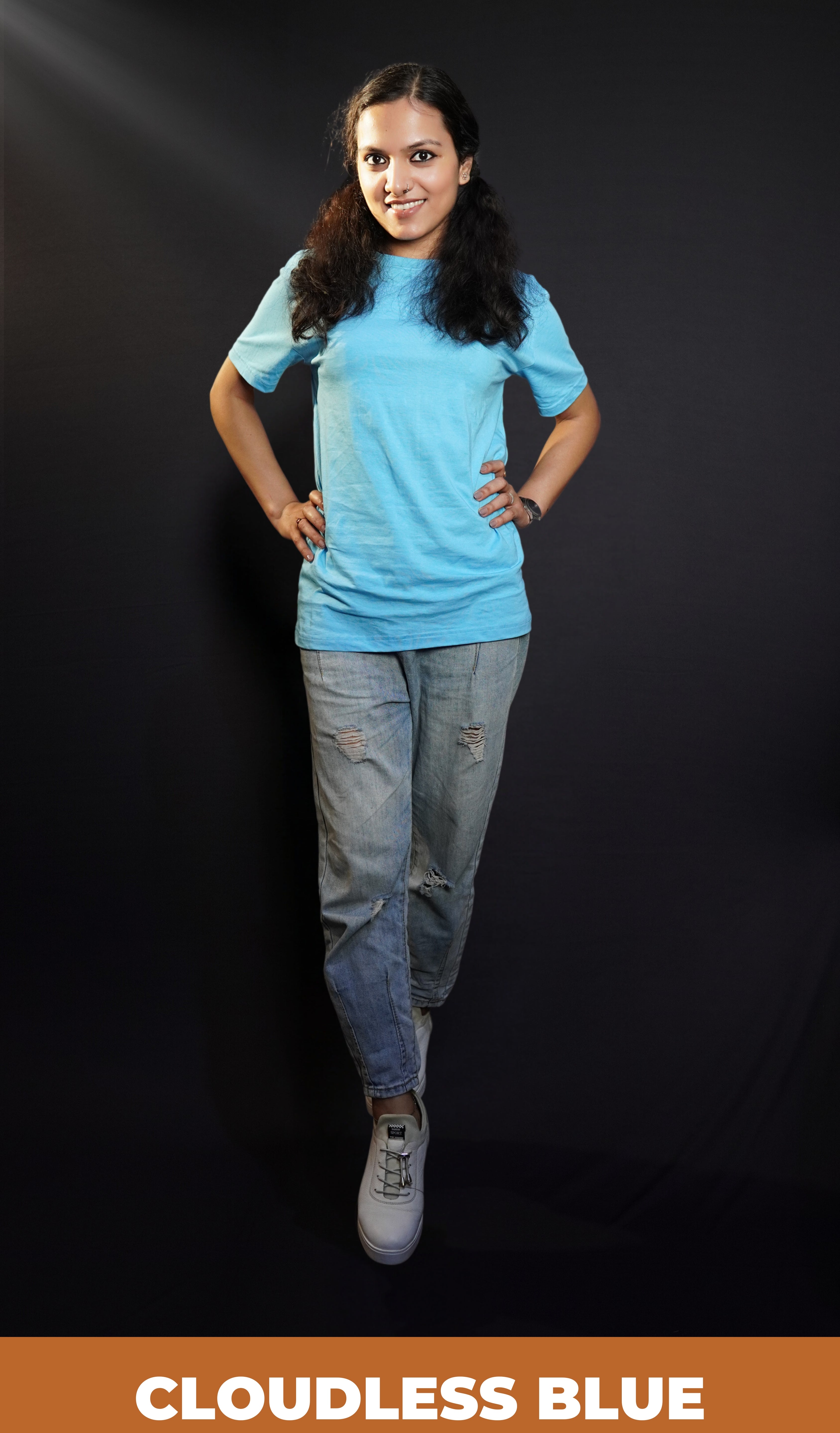 A stylish woman posing confidently at the camera with her hands on her waist, wearing short sleeved plain t shirt, showcasing a fashionable stylish look-Muselot
