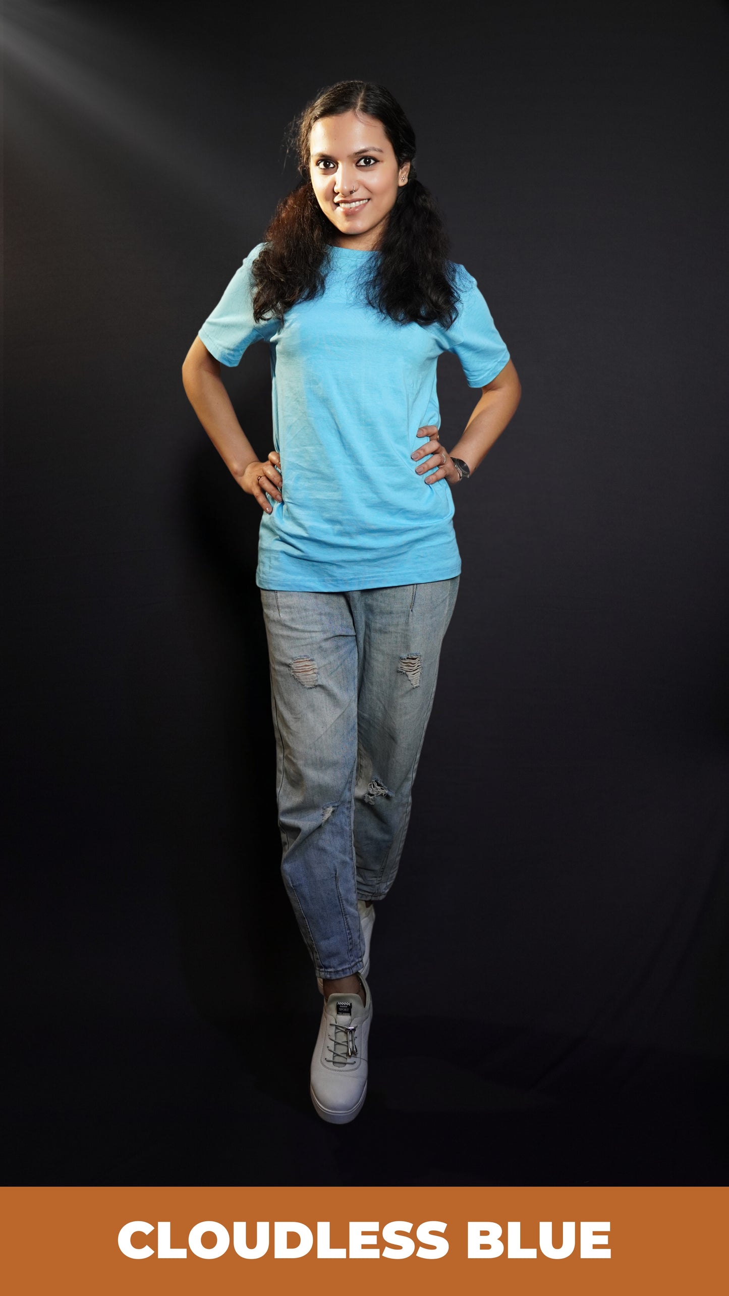 A stylish woman posing confidently at the camera with her hands on her waist, wearing short sleeved plain t shirt, showcasing a fashionable stylish look-Muselot