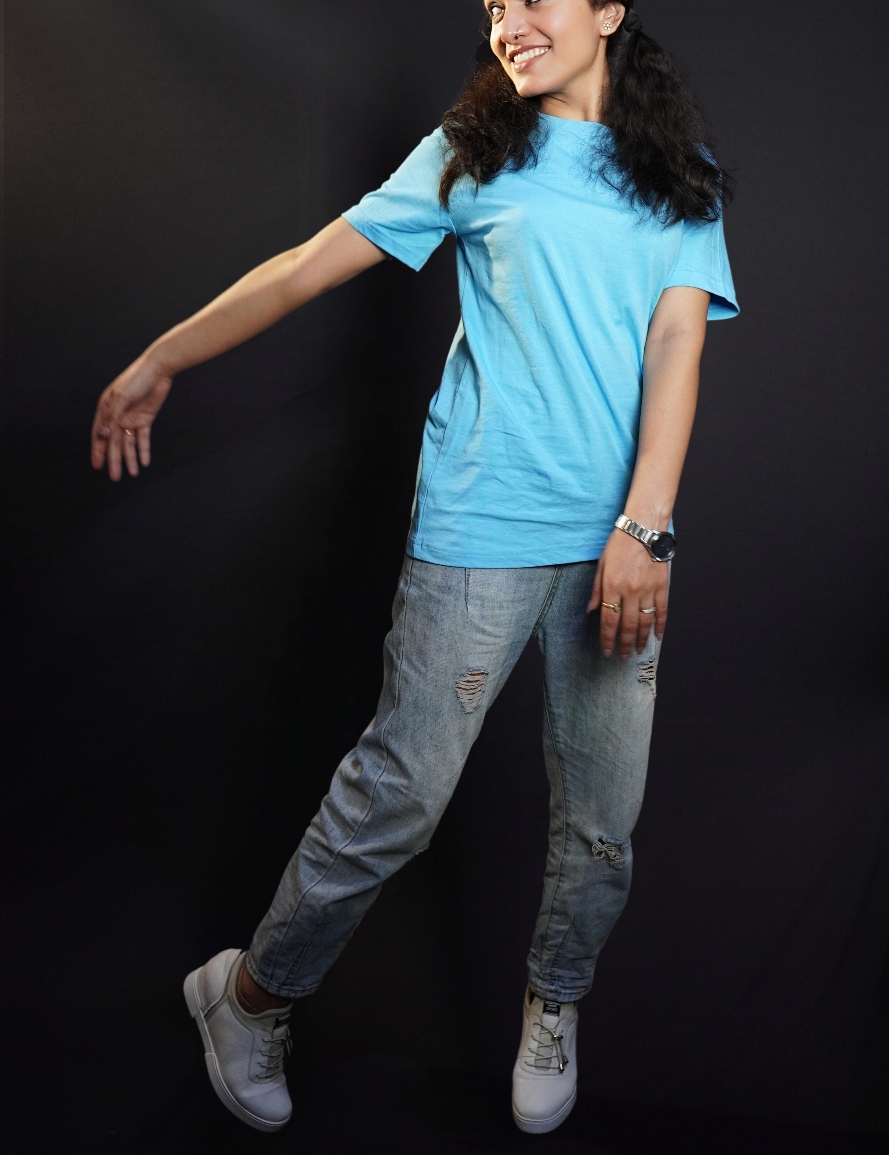 A short haired woman wearing a men's plus size plain t-shirt, standing with one hand swayed back, highlighting a cool slouchy fit-Muselot