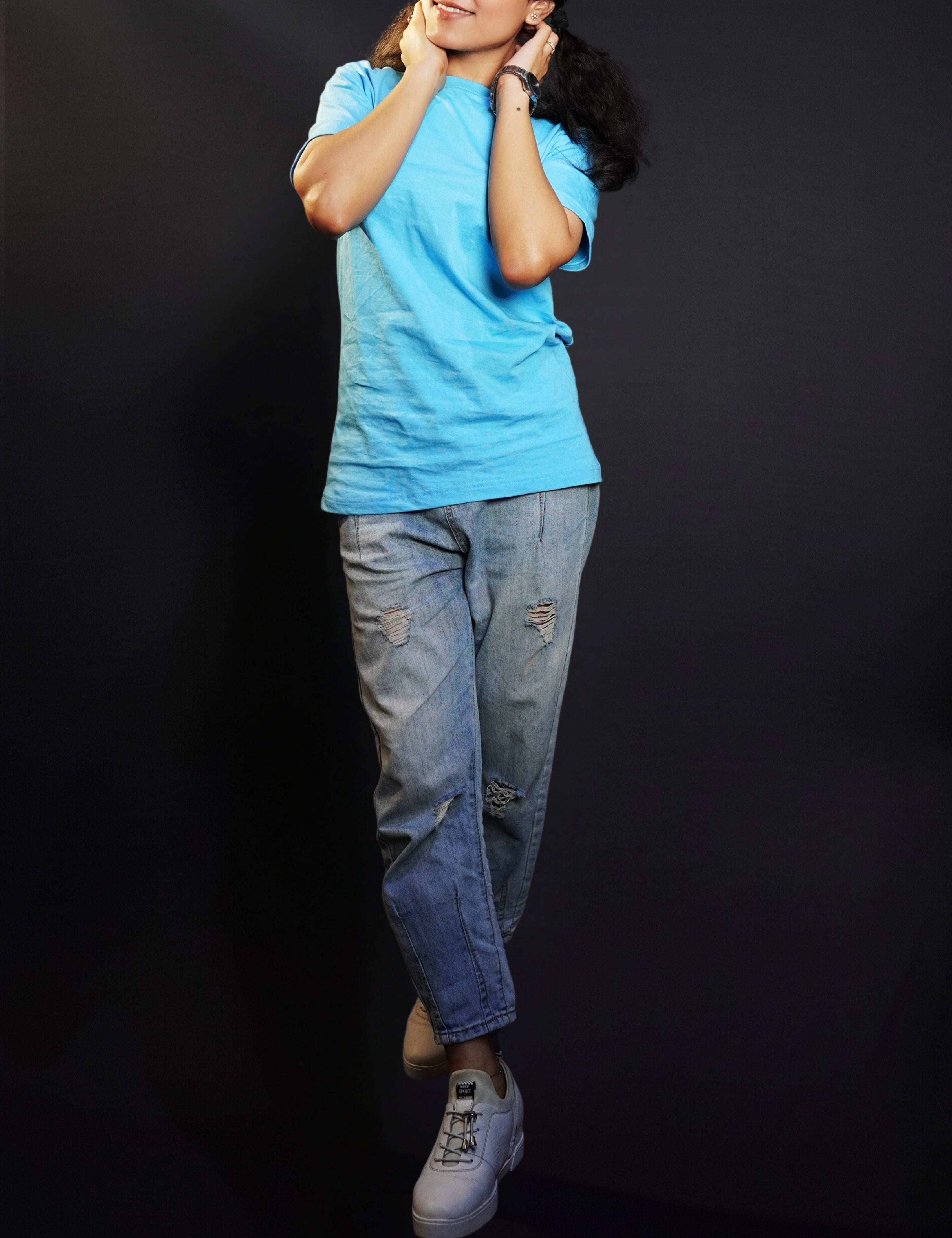 A model wearing cotton plain cloudless blue t-shirt, posing with her hands on the back of her neck, showcasing a cozy in vogue style-Muselot