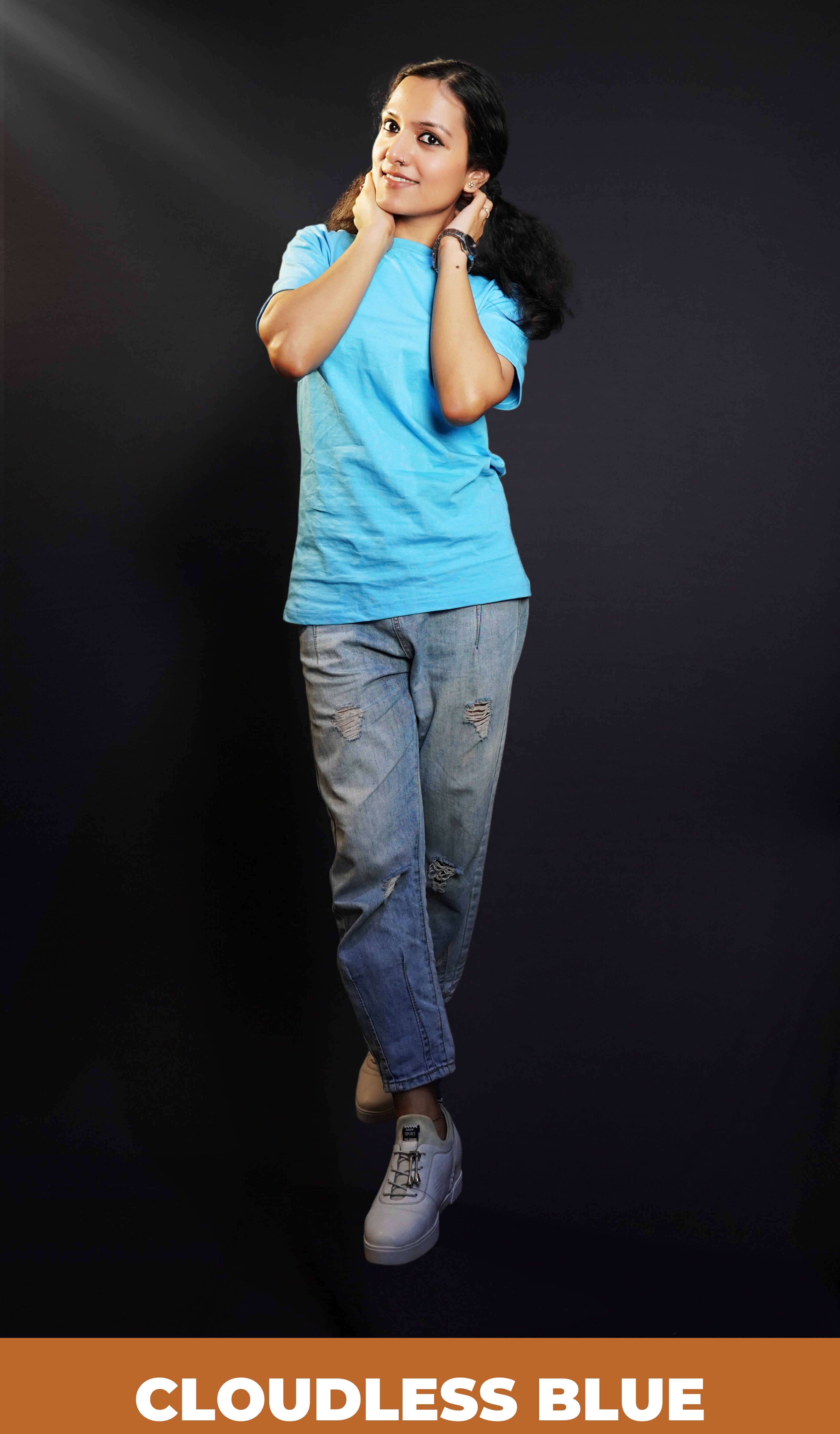 A model wearing cotton plain cloudless blue t-shirt, posing with her hands on the back of her neck, showcasing a cozy in vogue style-Muselot