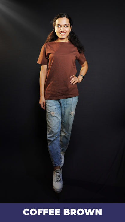 A woman posing happily with her one hand on her waist and other on her side, wearing a round neck plain long length t-shirt, highlighting a soft flexible style-Muselot