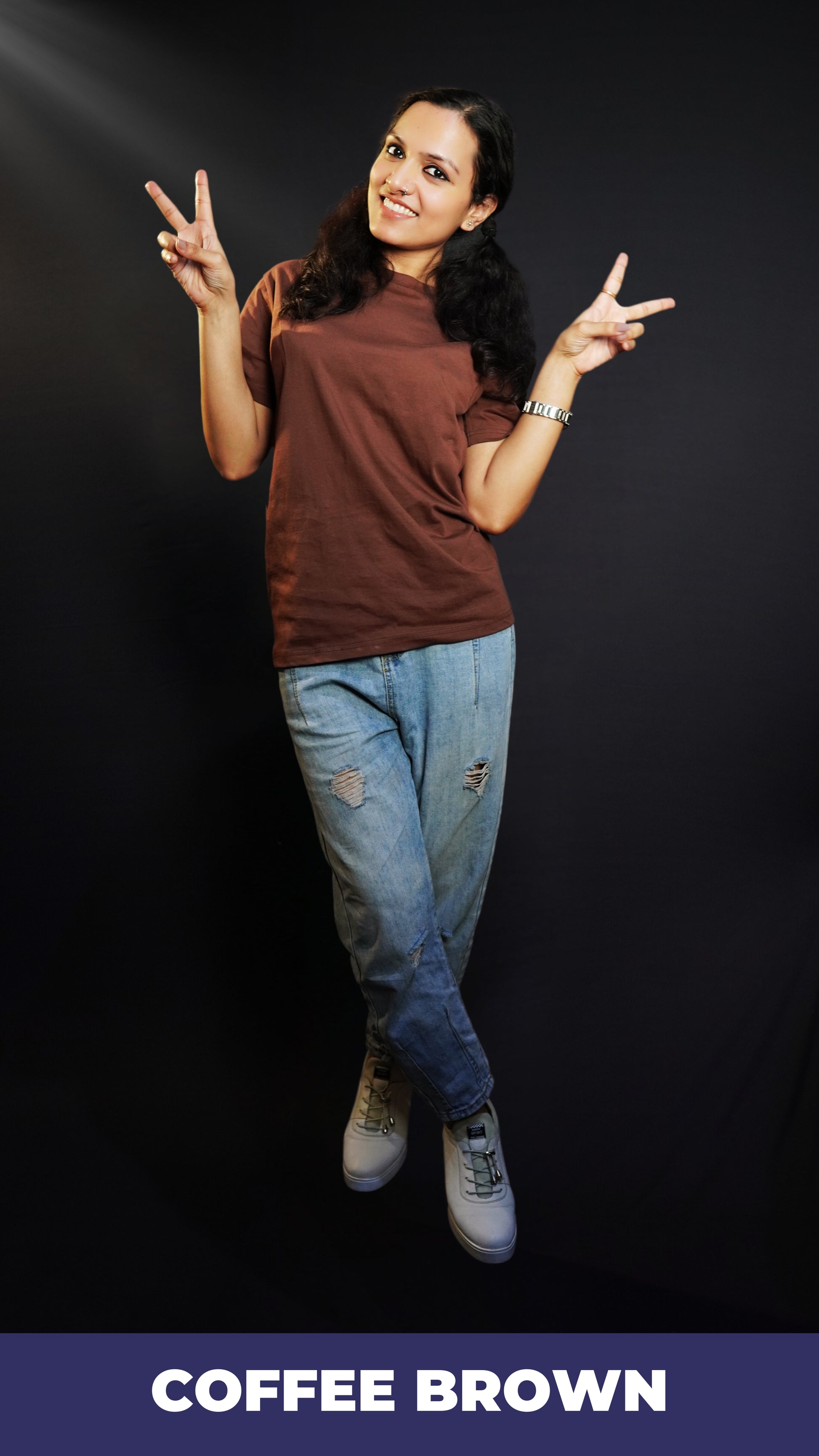 A woman happily posing by making a v sign with her fingers, wearing a plain adults round neck coffee brown t-shirt, showcasing a relaxed snug fit-Muselot