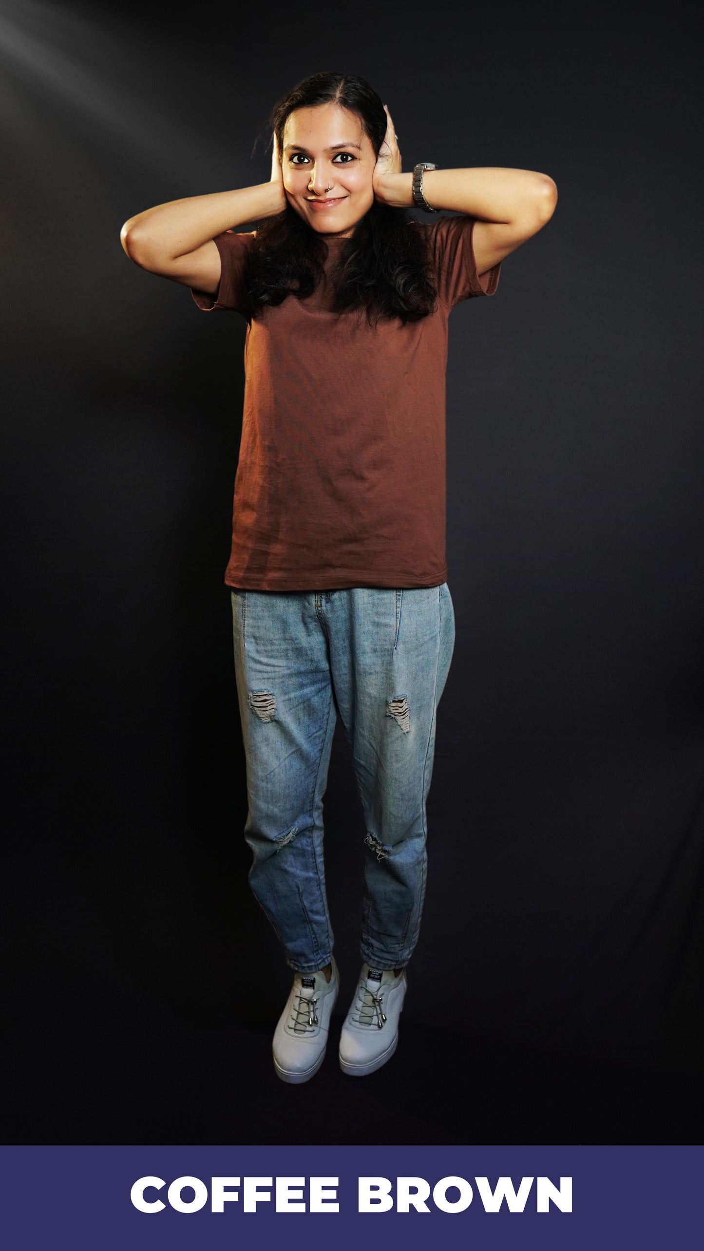 A woman wearing a coffee brown plain stretchable short sleeved t-shirt, posing with her hands on her ears, showcasing a roomy comfortable fit-Muselot