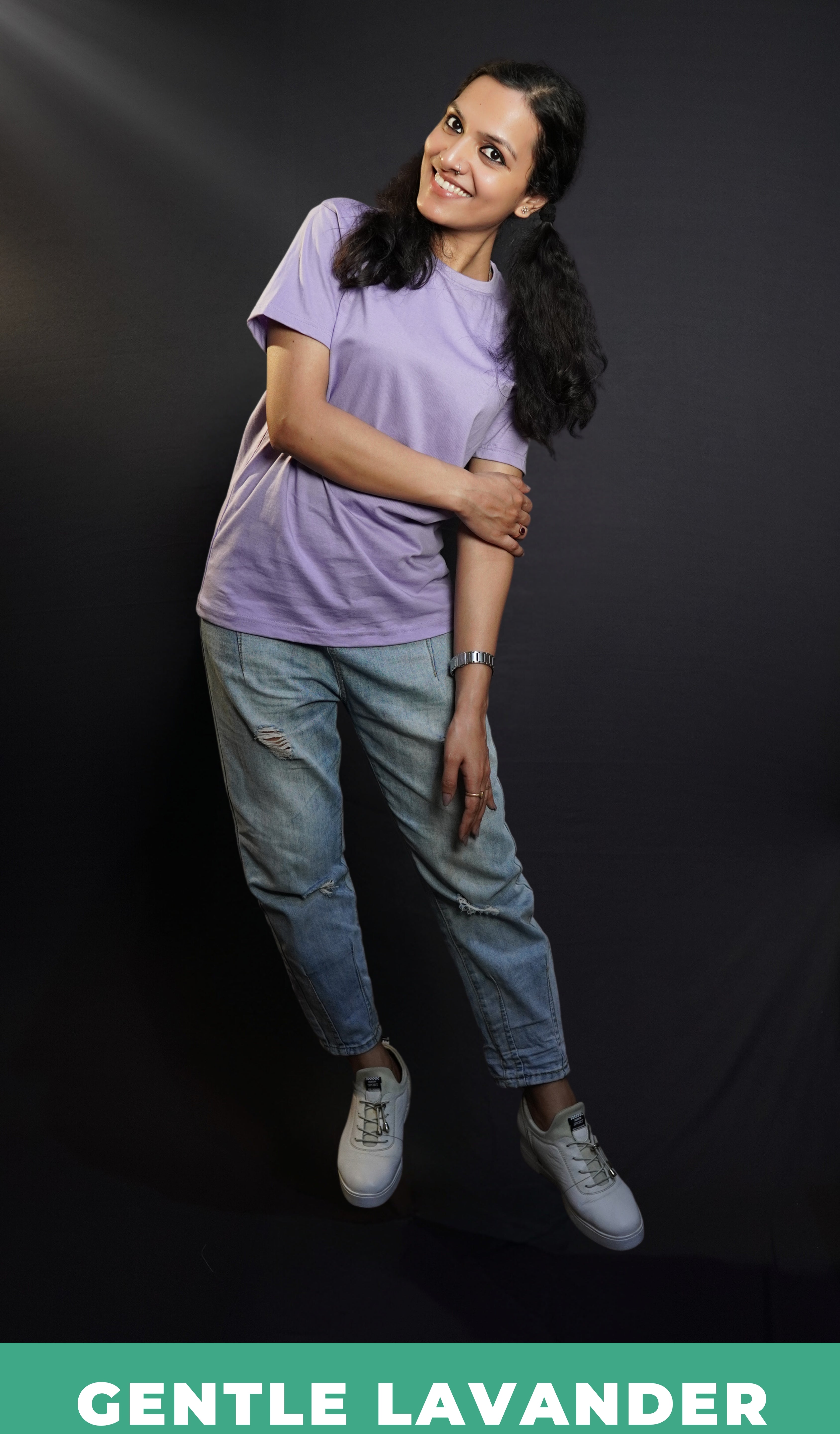 A woman wearing an adult's stretchable round neck short sleeved gentle lavender t-shirt, posing with her one hand grabbing her elbow, slightly bent to her side, highlighting a casual snug fit-Muselot