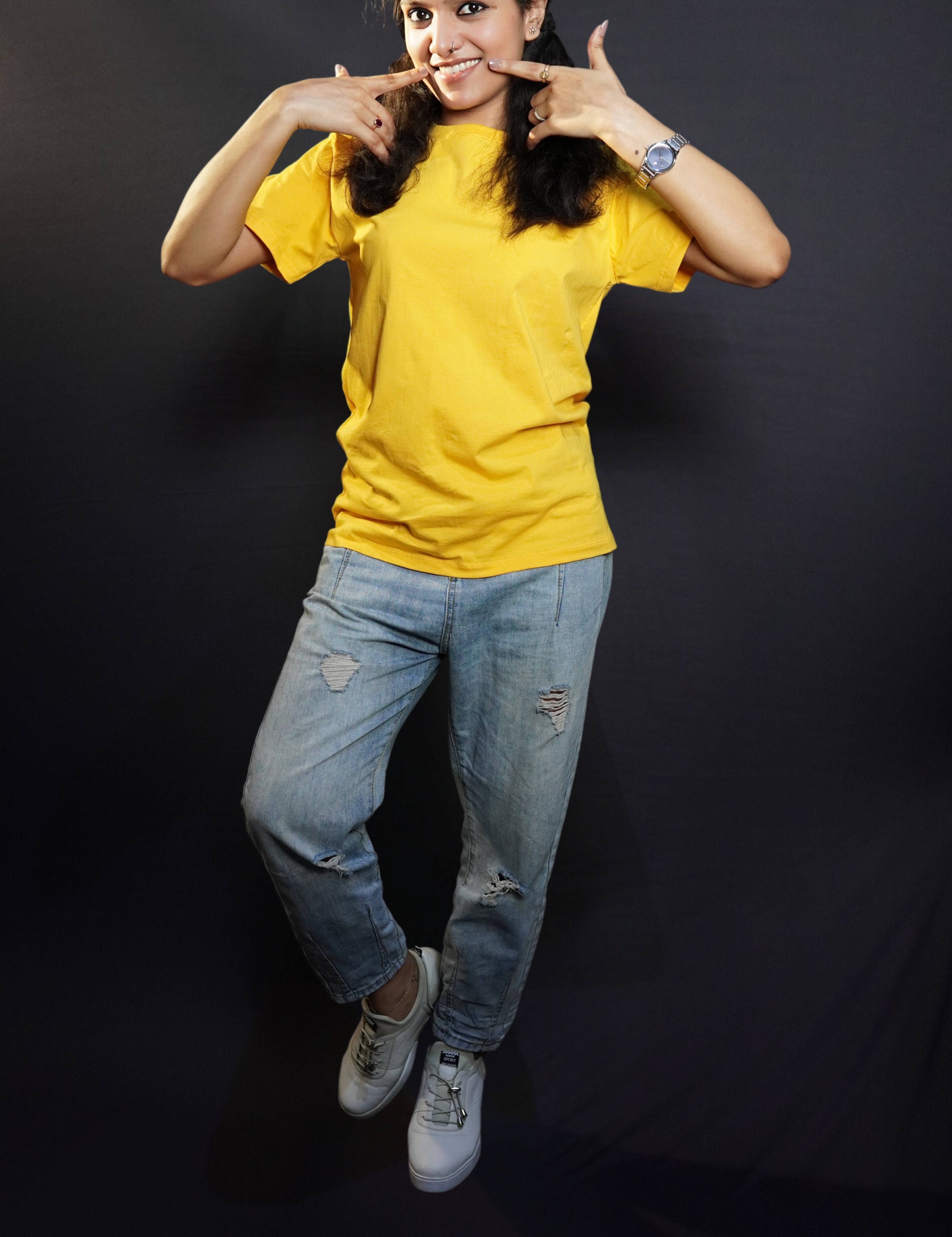 A stylish model wearing plain casual round neck T shirt posing against a dark background-Muselot