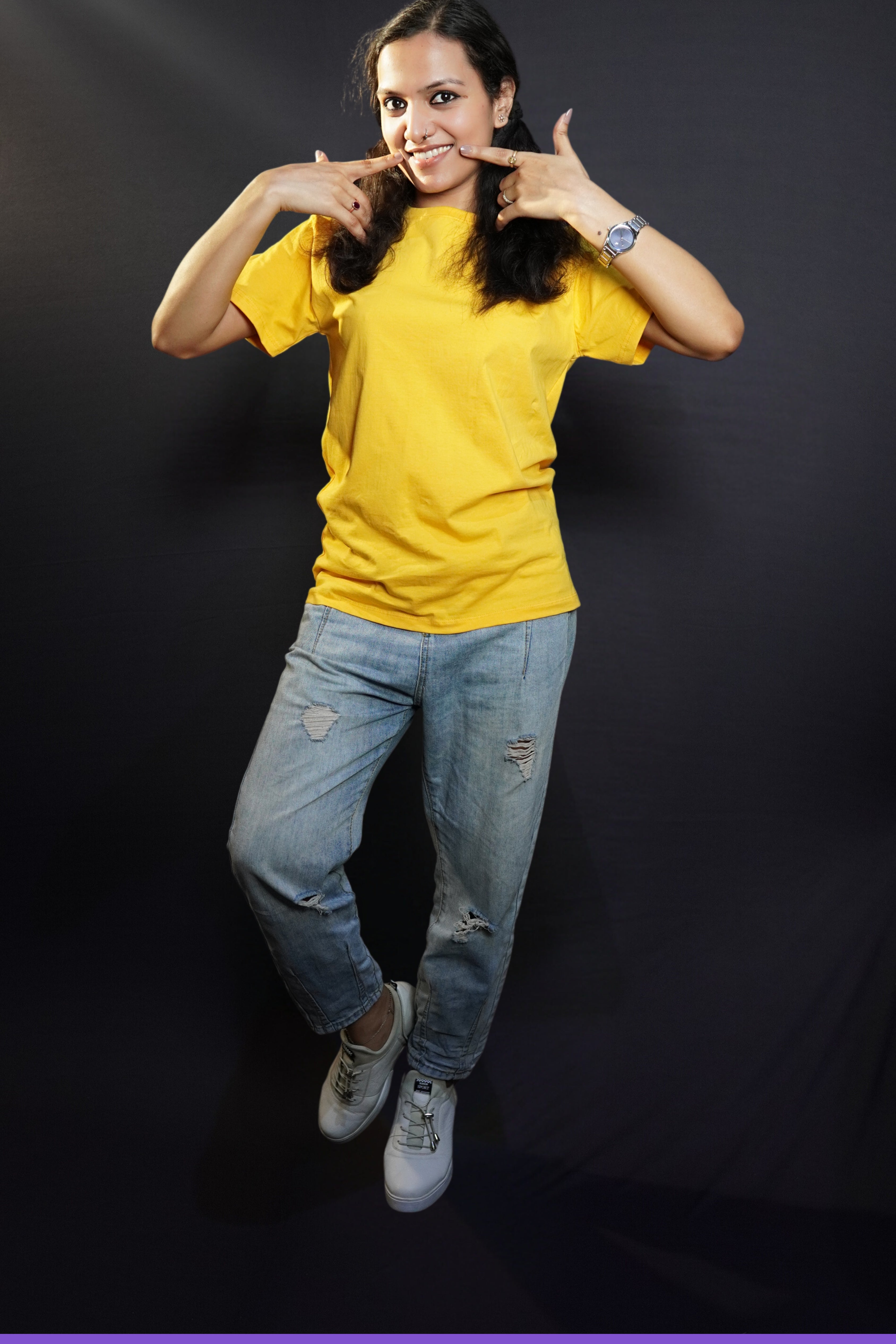 A stylish model wearing plain casual round neck T shirt posing against a dark background-Muselot