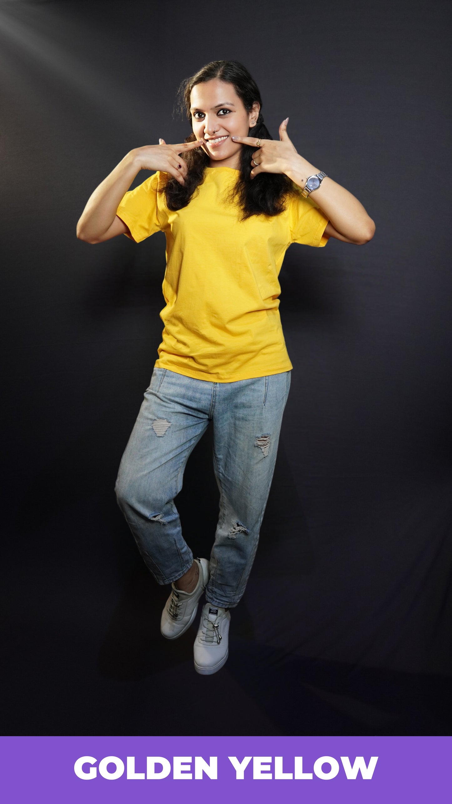 A stylish model wearing plain casual round neck T shirt posing against a dark background-Muselot