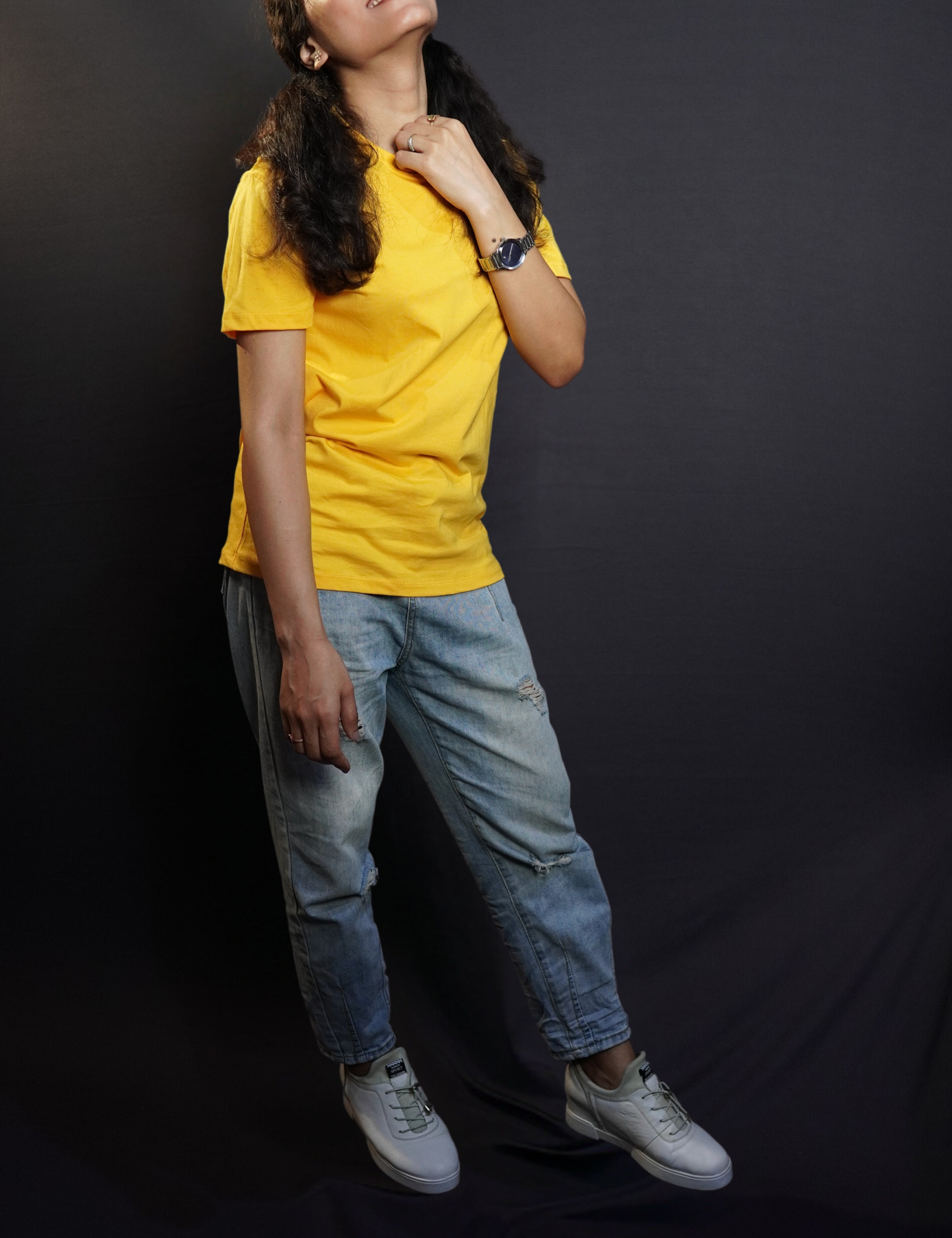 A model wearing plain men snug fit T shirt posing happily against a dark background-Muselot