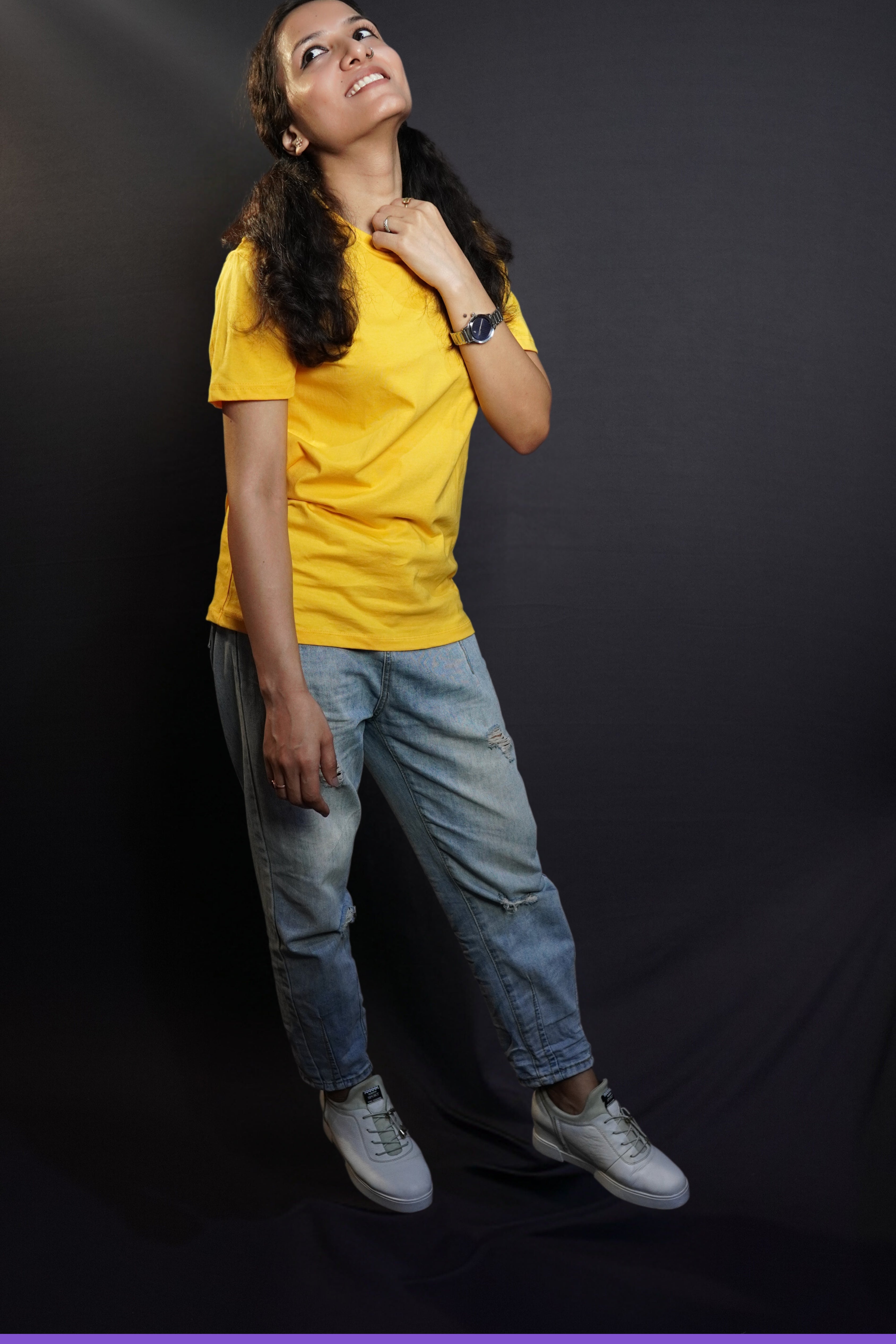 A model wearing plain men snug fit T shirt posing happily against a dark background-Muselot