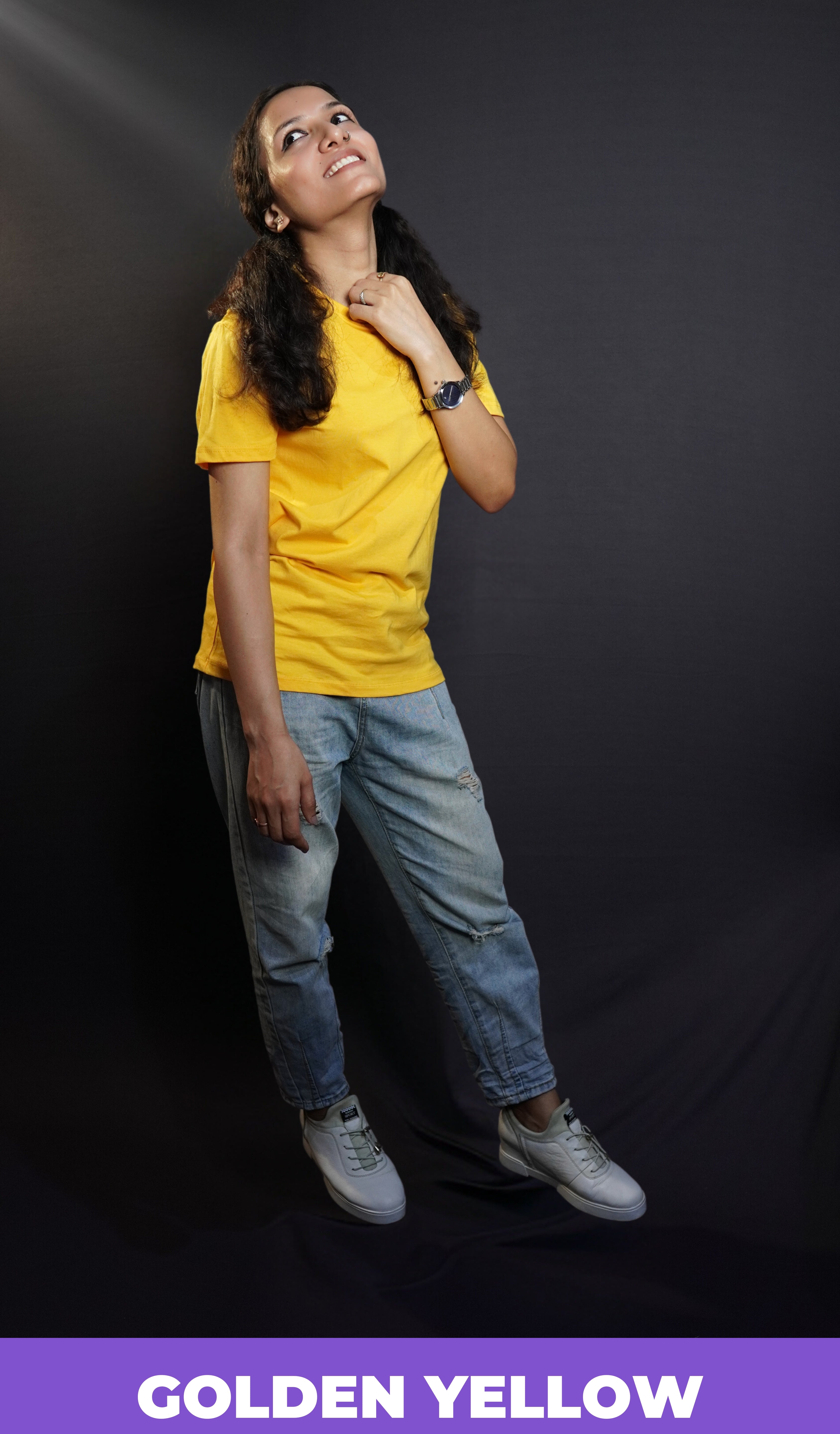 A model wearing plain men snug fit T shirt posing happily against a dark background-Muselot