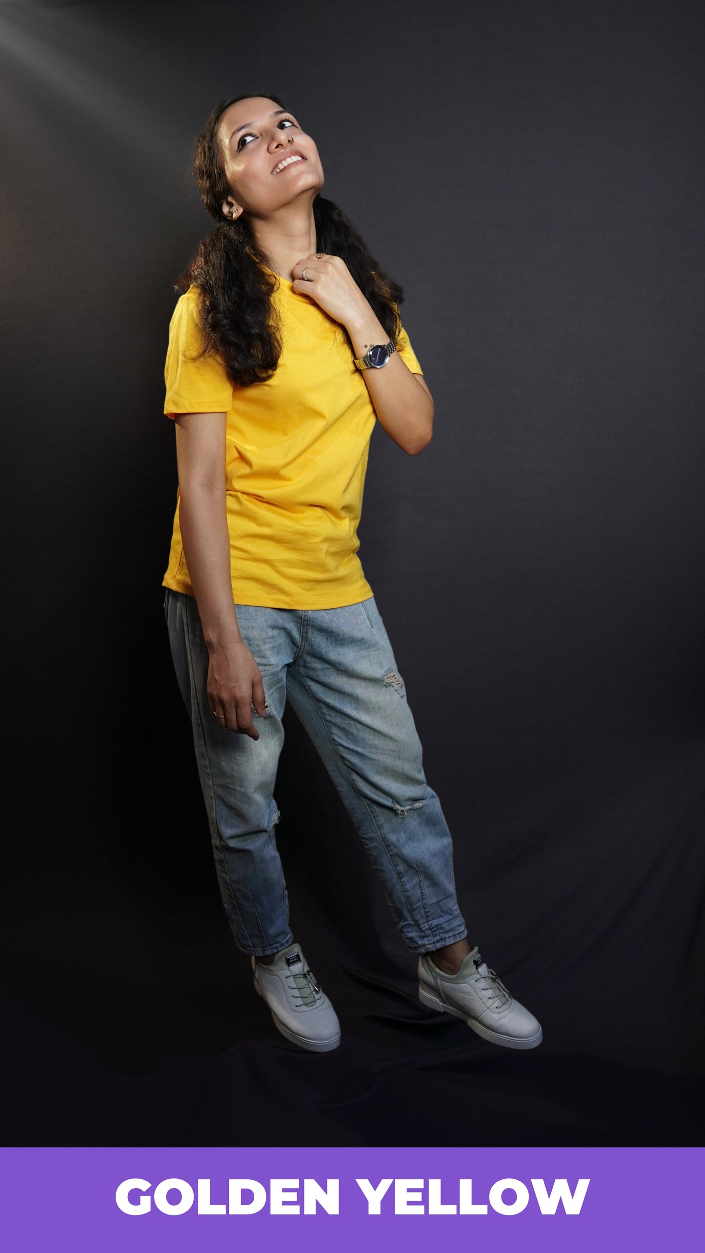 A model wearing plain men snug fit T shirt posing happily against a dark background-Muselot