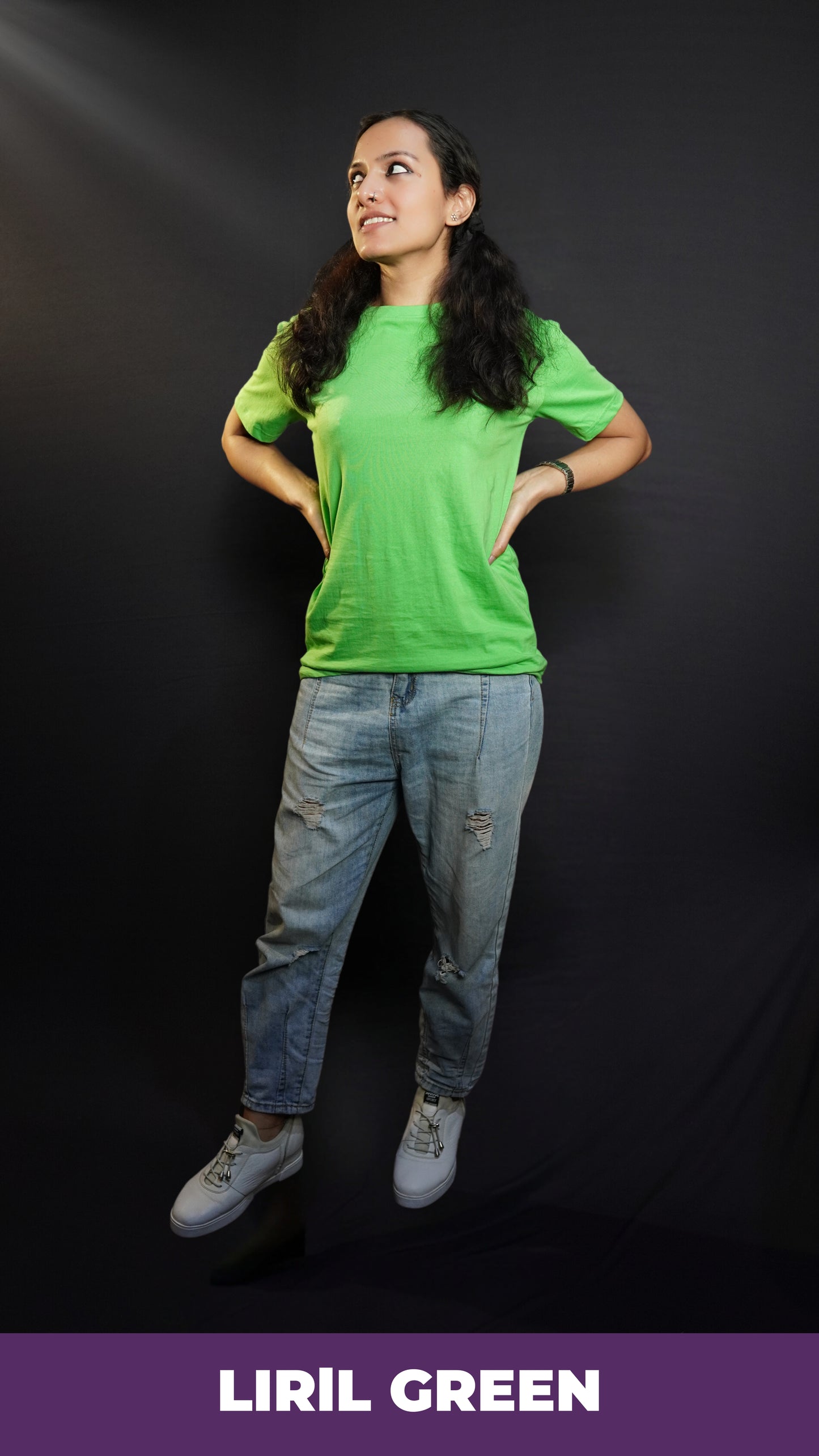 A stylish model posing with her hands on her sides looking sideways, wearing a lime green cotton long length adult's t-shirt, highlighting a trendy snug fit-Muselot