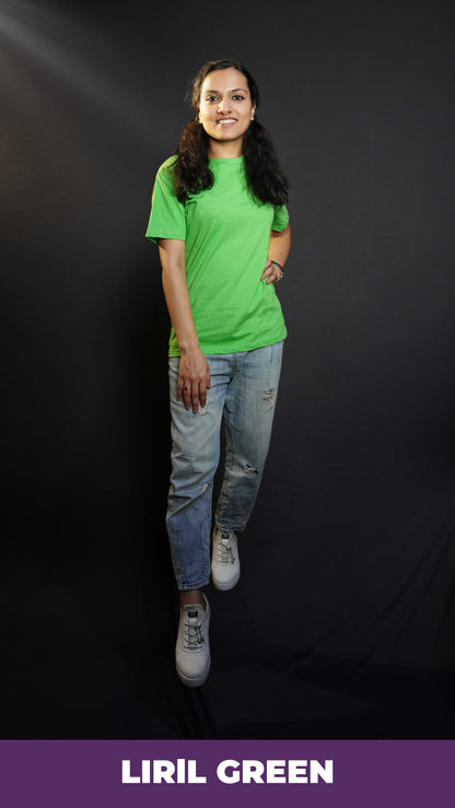 An elegant model wearing a liril green quick drying plain long length t-shirt, posing confidently with her hand on her waist and another on her thigh, smiling brightly, showcasing a modern informal look-Muselot