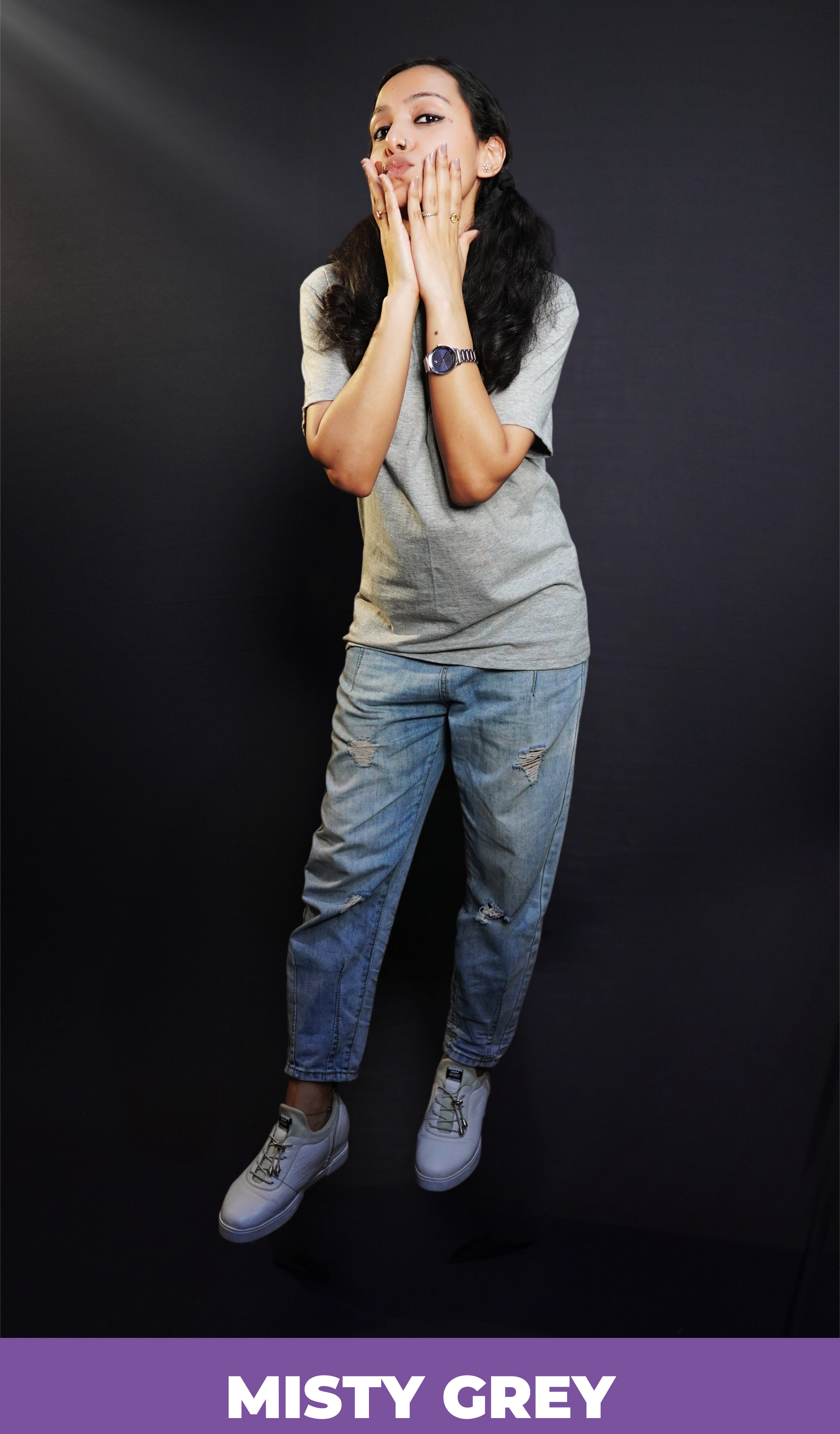 A woman posing with her hands on her cheeks, pouting as she slightly bends forward, wearing a misty grey plain unisex round neck t-shirt, showcasing a cute trendy look-Muselot