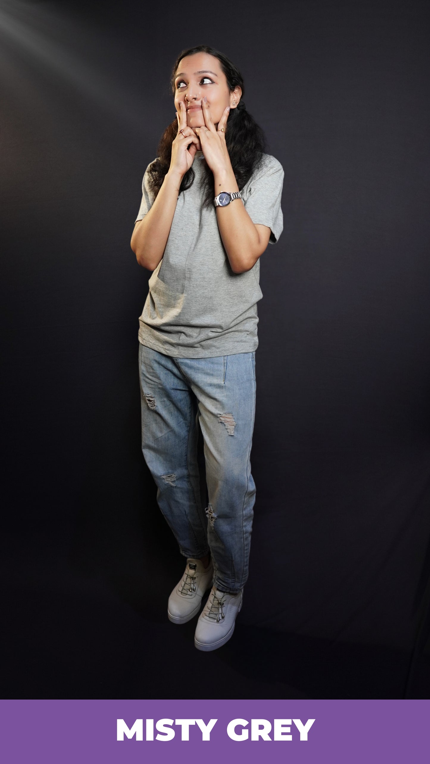 A woman wearing a long length round neck short sleeved plain t-shirt, posing with her hand on her cheeks making a v with her fingers, showcasing a soft homey fit-Muselot