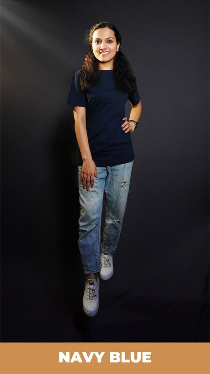 A stylish model wearing a unisex plain round neck navy blue t-shirt, posing with her hand on her waist and other on her thigh, showcasing a trendy snug fit-Muselot