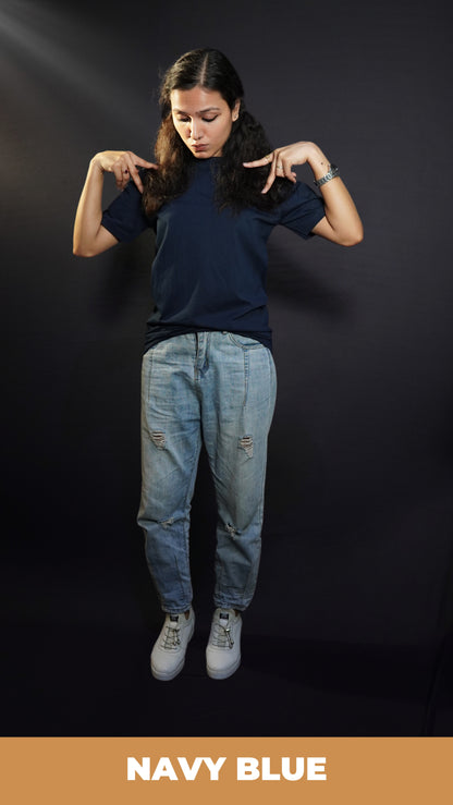 A woman wearing a round neck quick drying short sleeved navy blue t-shirt, posing with her hands making a v on her shoulder, showcasing a cool cozy fit-Muselot