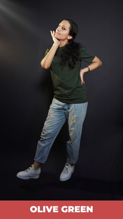 A woman with her hand under her chin and other on her waist, wearing a plus size short sleeved quick drying olive green t-shirt, highlighting an in demand baggy fit-Muselot