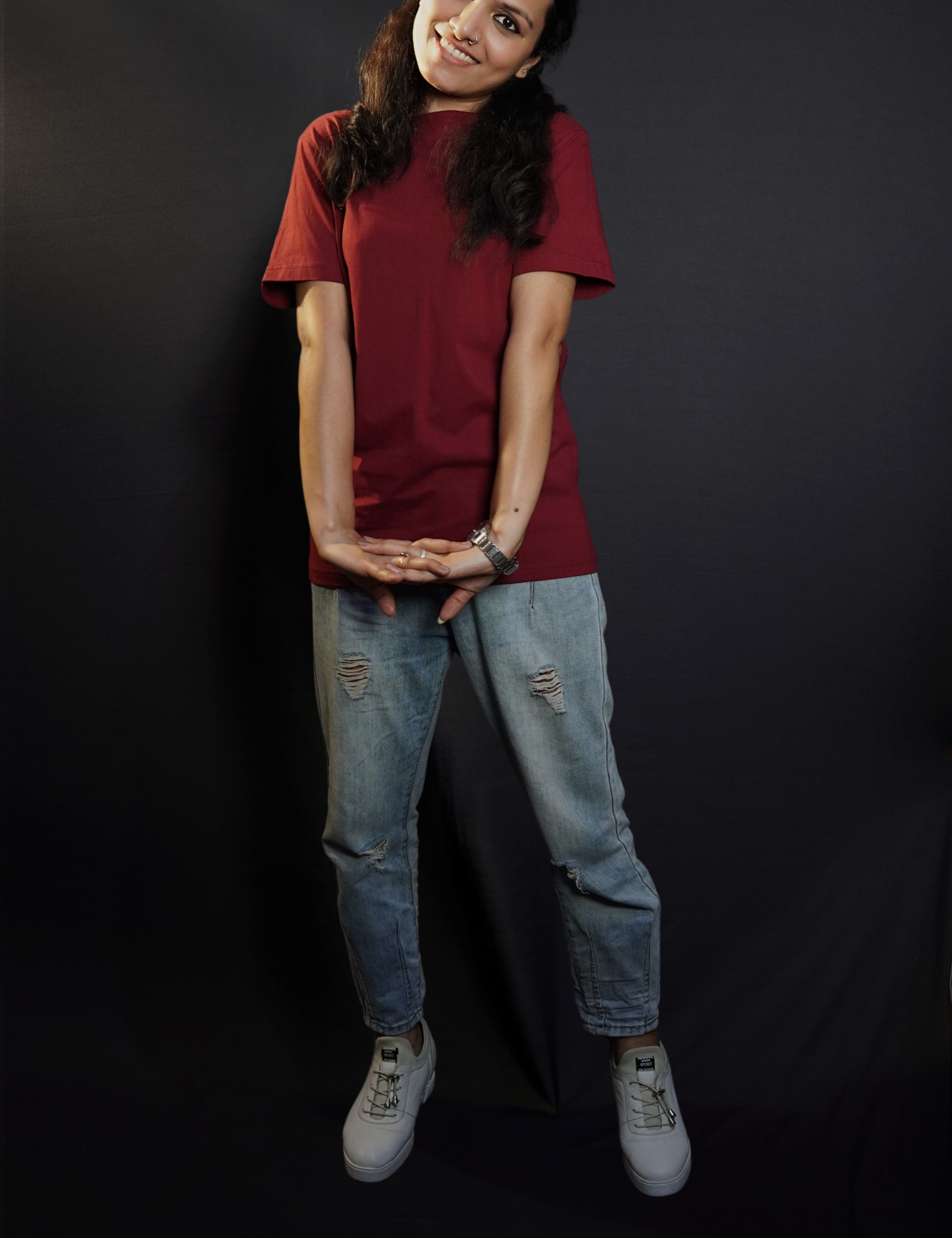 A woman wearing men's cotton short sleeved moisture wicking rich maroon t-shirt, posing with her hand stretched in front of her, highlighting a casual everyday fit-Muselot