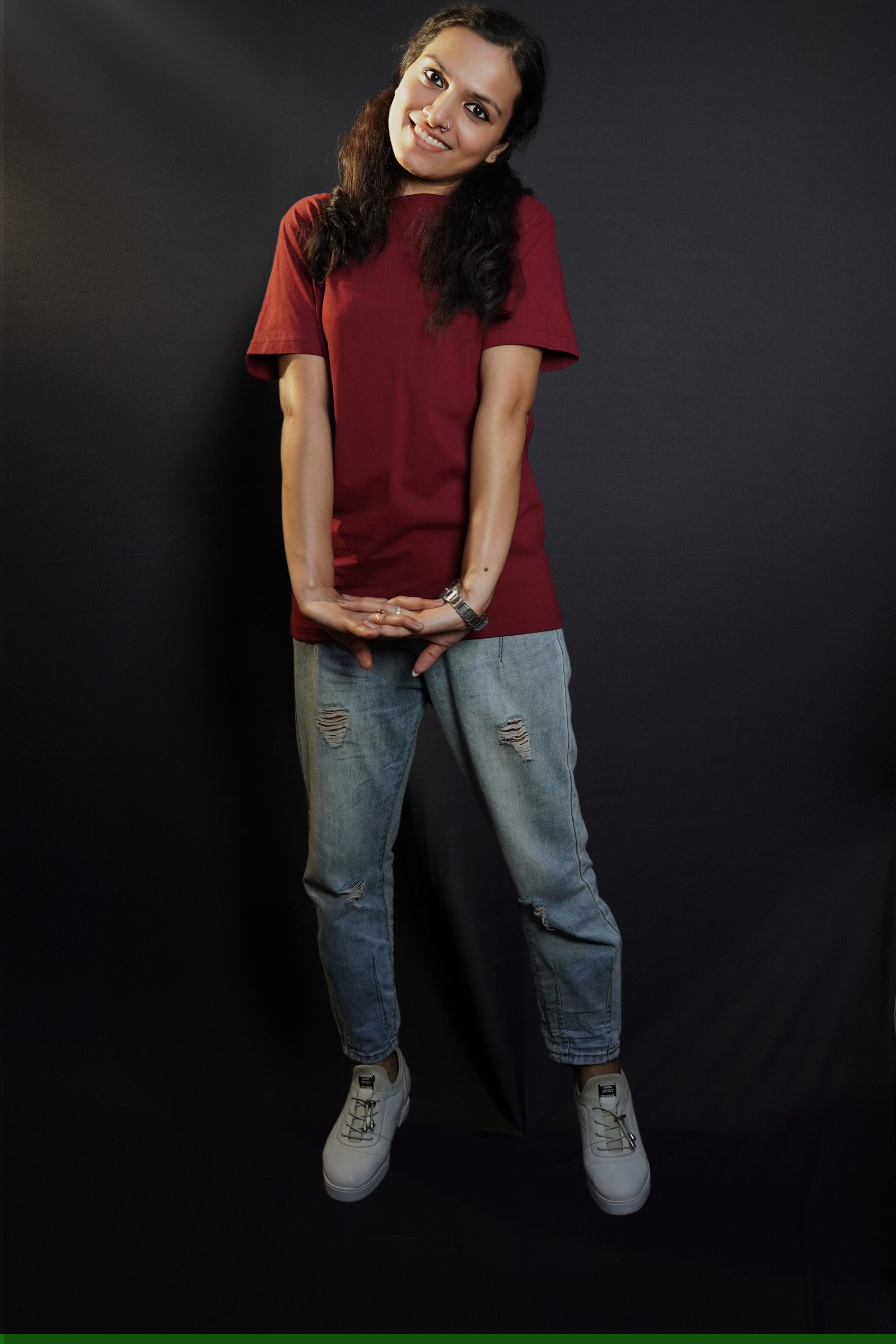 A woman wearing men's cotton short sleeved moisture wicking rich maroon t-shirt, posing with her hand stretched in front of her, highlighting a casual everyday fit-Muselot