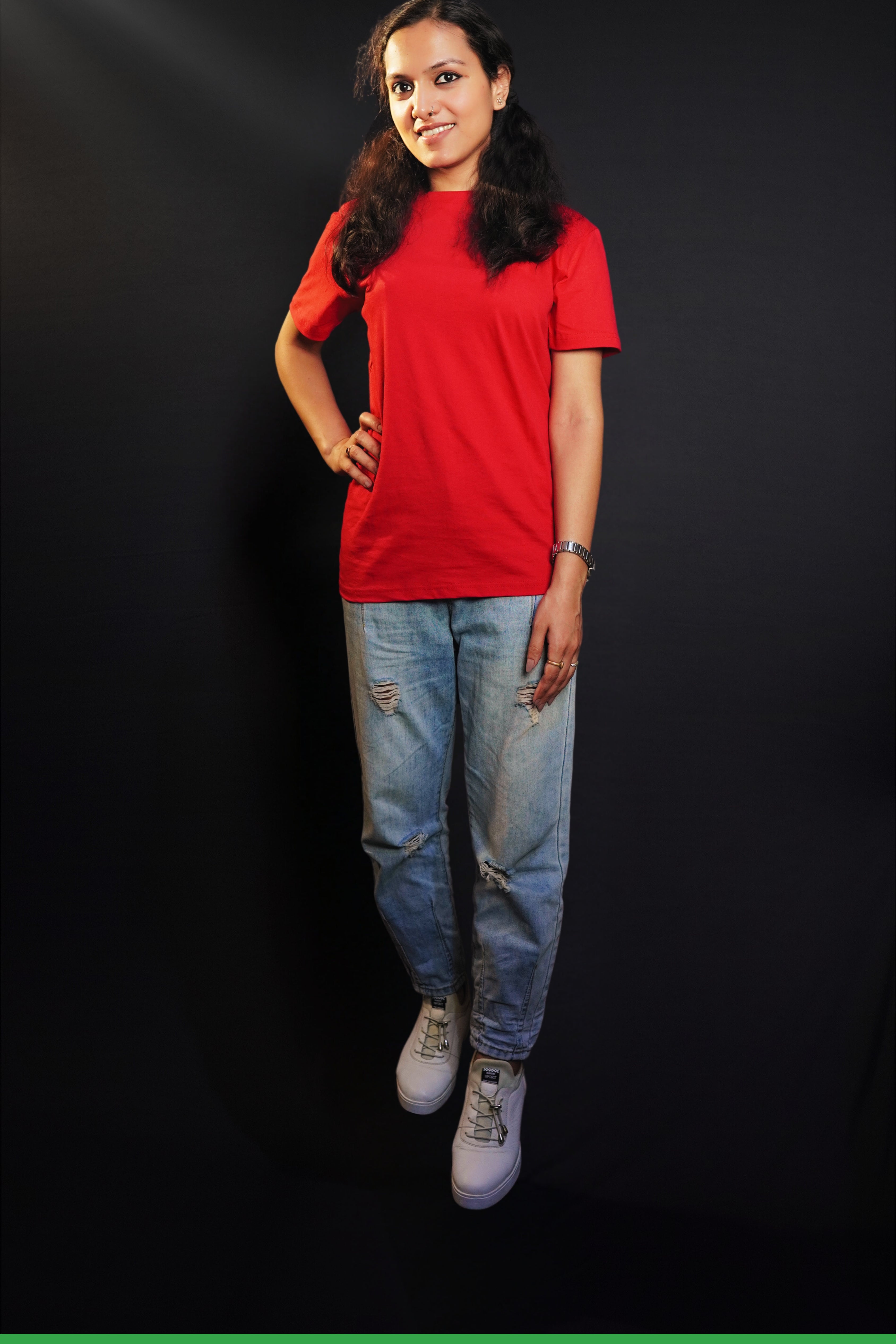 A stylish model standing straight as her hand hangs on her side and another on her waist, wearing a unisex plain rosy red round neck t-shirt. showcasing a fashionable in vogue look-Muselot