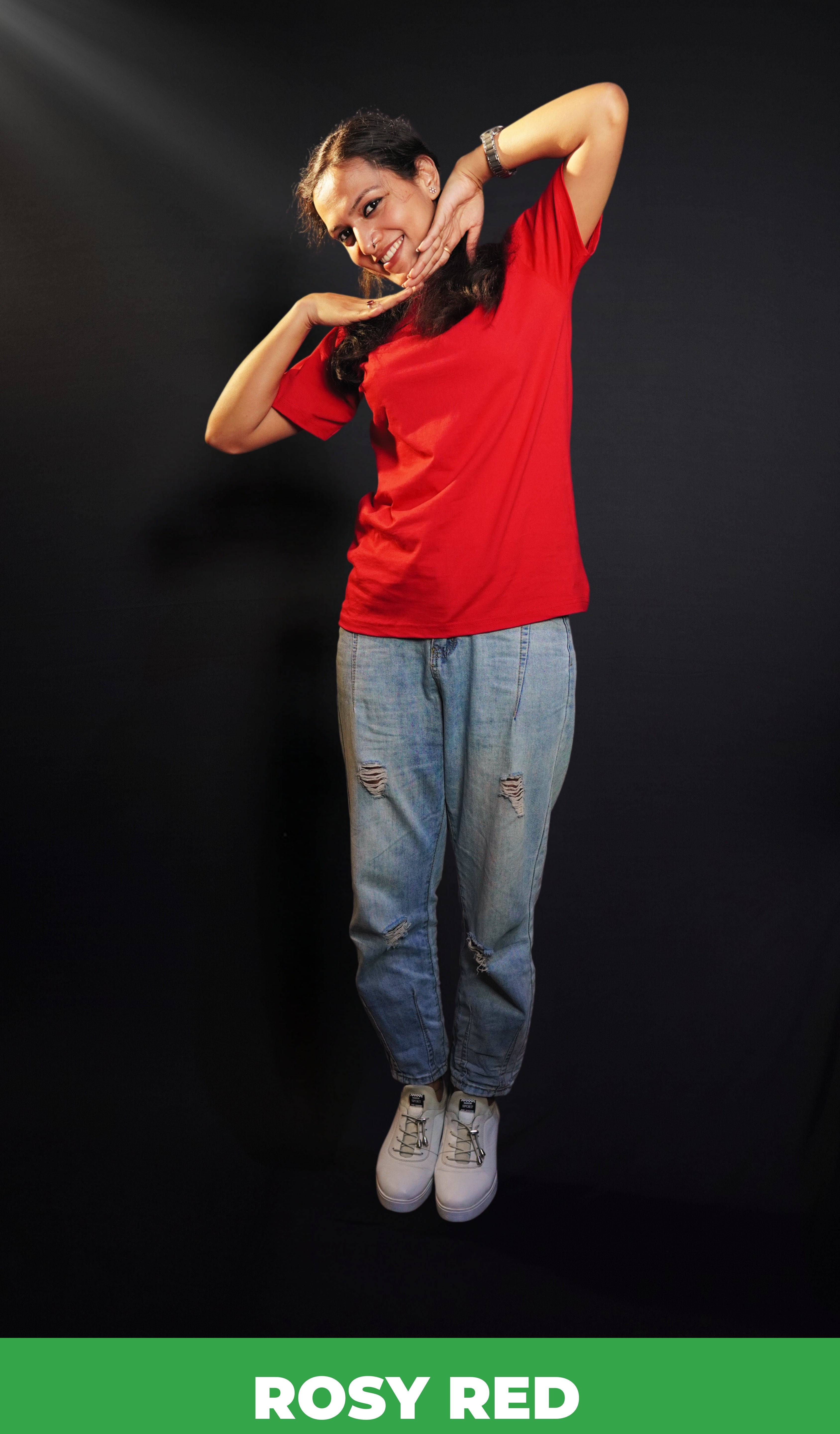 A happy woman wearing an adult's summer round neck moisture wicking rosy red t-shirt, posing with her hands below her chin, smiling happily, highlighting an aesthetic cozy look-Muselot