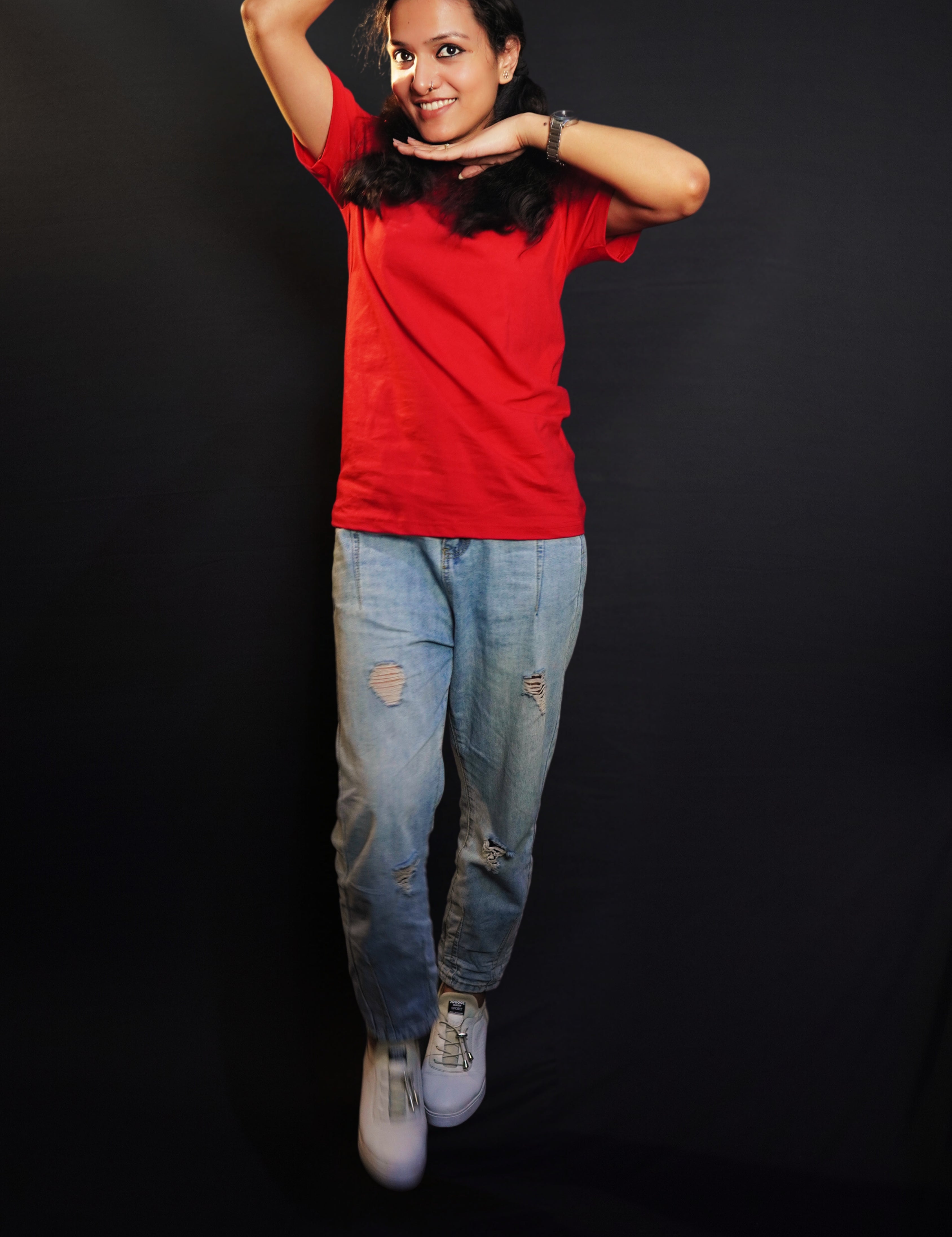 A woman wearing a girl's cotton short sleeved quick drying rosy red t-shirt, posing with her palms upon her head and under her chin, showcasing an informal snug fit-Muselot