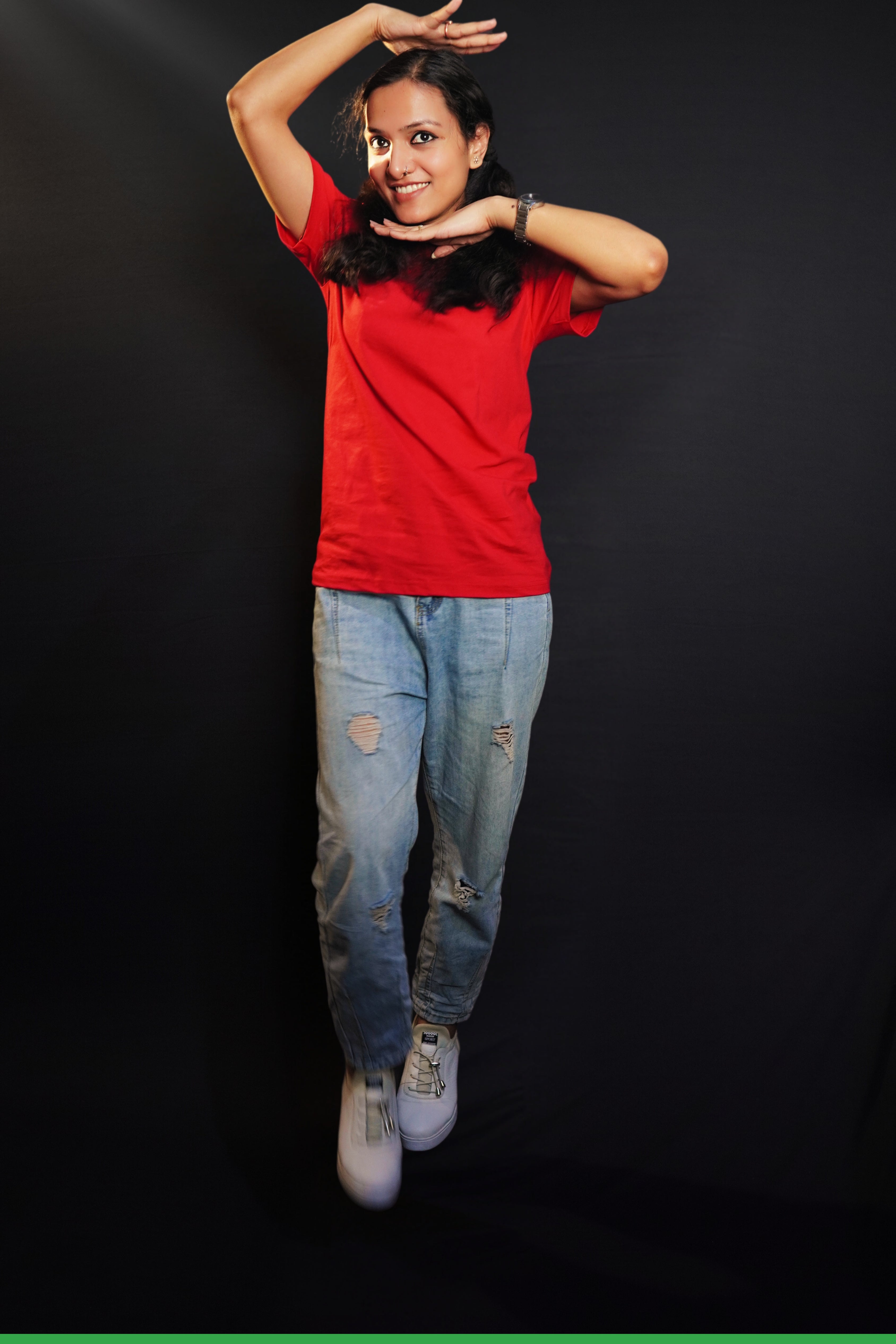 A woman wearing a girl's cotton short sleeved quick drying rosy red t-shirt, posing with her palms upon her head and under her chin, showcasing an informal snug fit-Muselot