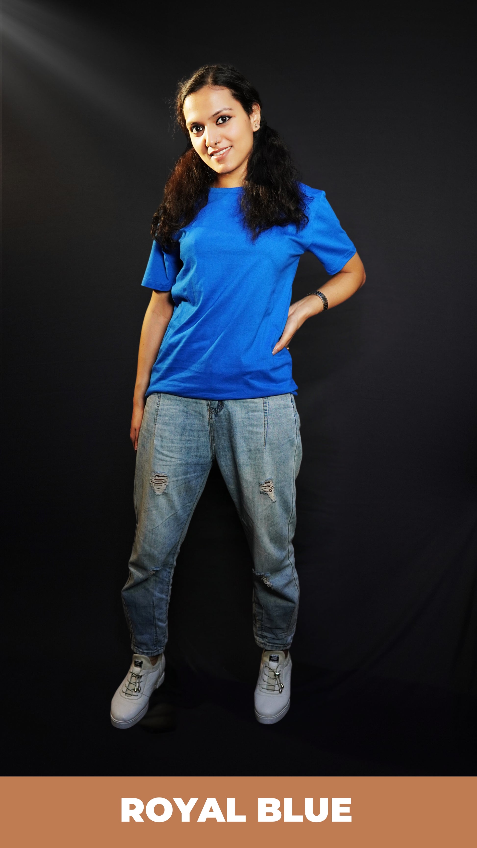 A woman wearing a cotton short sleeved round neck long t-shirt, posing with her hand on her waist and another hanging behind her, highlighting a modish slouchy fit-Muselot