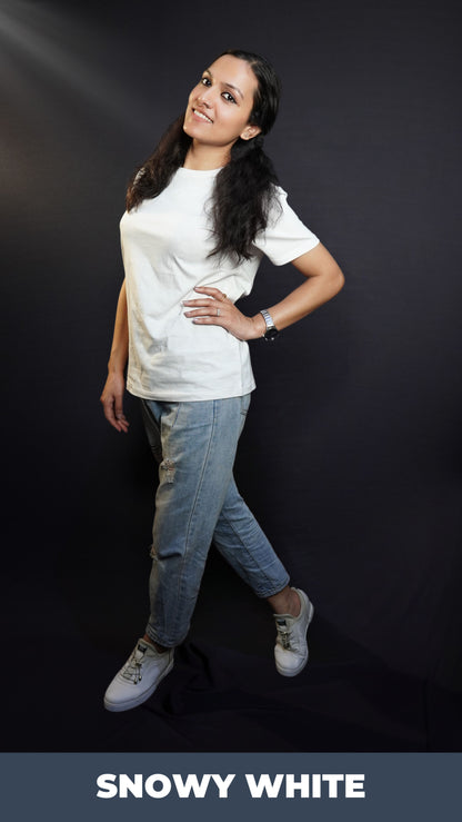 A woman wearing a moisture wicking cotton round neck snowy white girl's t-shirt, posing with her hand on her waist and another hanging on her side as she stands sideways, highlighting a casual everyday look-Muselot