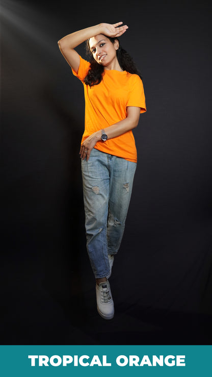 A stylish model posing with her hand upon her forehead and other gently hugging her sideways, wearing a men's plus size long length plain orange t-shirt, highlighting a stylish in vogue look-Muselot